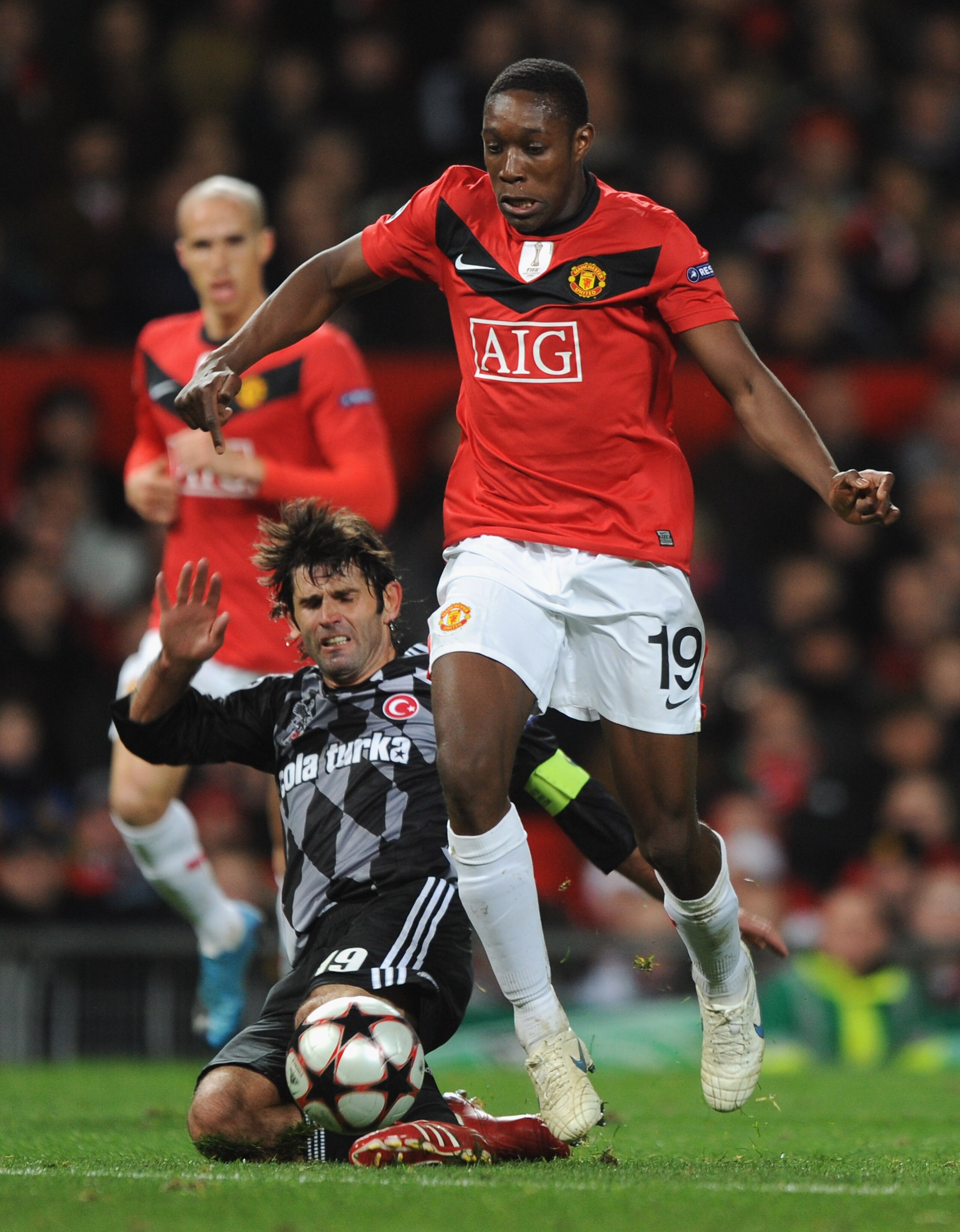 MANCHESTER, ENGLAND - NOVEMBER 25:  Ibrahim Uzulmez of Besiktas tackles Danny Welbeck of Manchester United during the UEFA Champions League Group B match between Manchester United and Besiktas at Old Trafford on November 25, 2009 in Manchester, England.