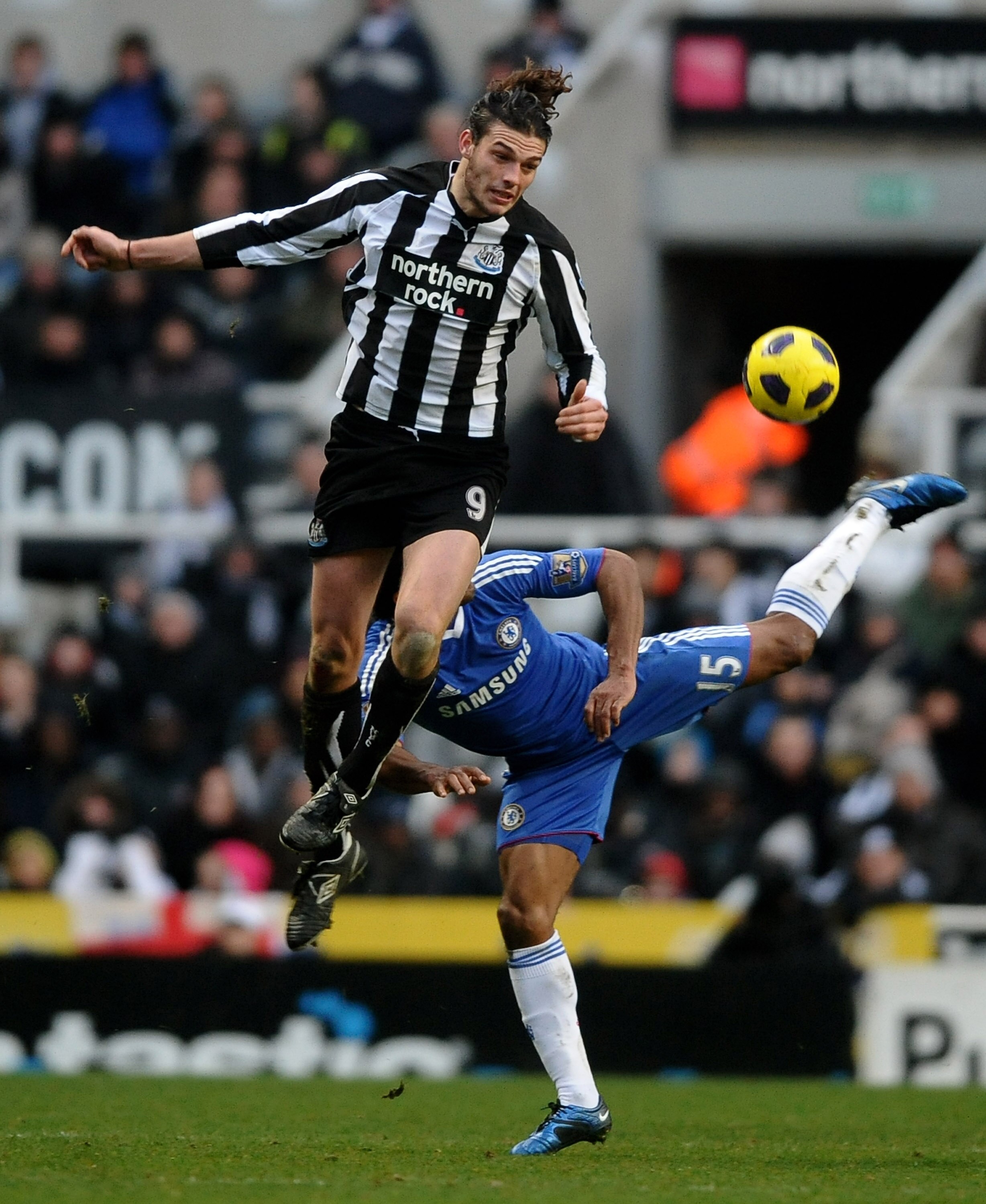 NEWCASTLE UPON TYNE, ENGLAND - NOVEMBER 28:  Andy Carroll of Newcastle United competes with Florent Malouda of Chelsea during the Barclays Premier League match between Newcastle United and Chelsea at St James' Park on November 28, 2010 in Newcastle, Engla