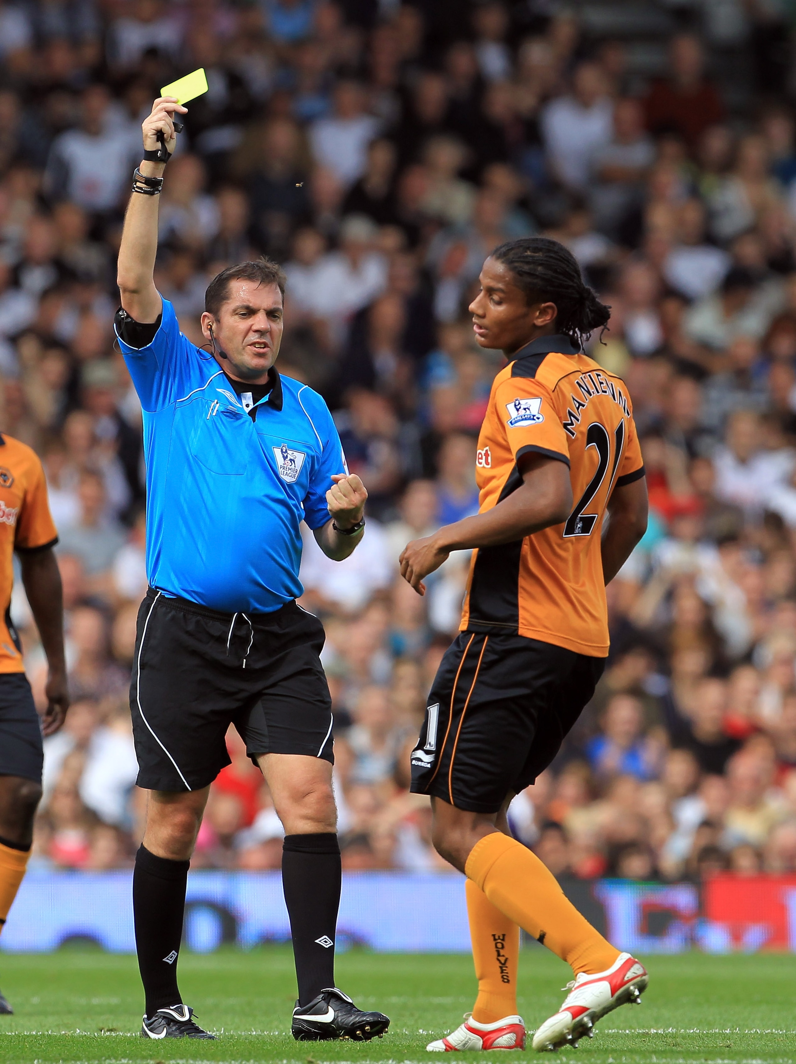 LONDON, ENGLAND - SEPTEMBER 11:  Phil Dowd the referee gives Michael Mancienne of Wolves a yellow card during the Barclays Premier League match between Fulham and Wolverhampton Wanderers at Craven Cottage on September 11, 2010 in London, England.  (Photo