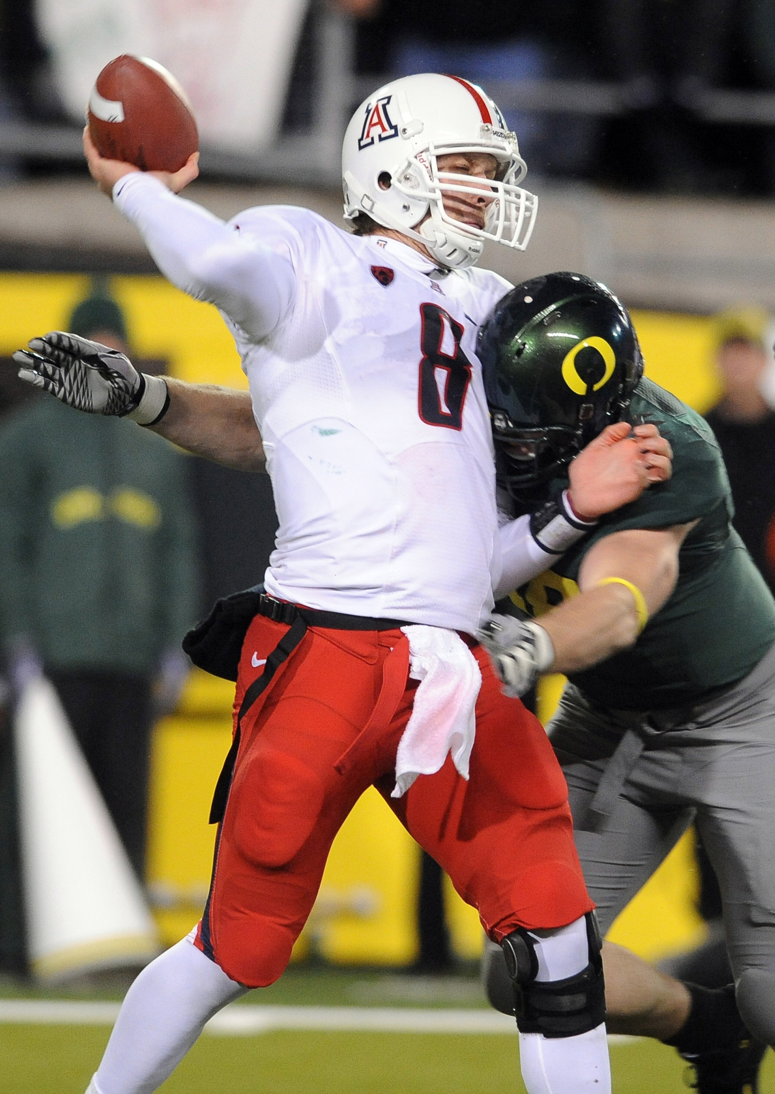 EUGENE, OR - NOVEMBER 26: Defensive end Brandon Bair #88 of the Oregon Ducks hits quarterback Nick Foles #8 of the Arizona Wildcats in the fourth quarter of the game at Autzen Stadium on November 26, 2010 in Eugene, Oregon. The Ducks won the game 48-29. (