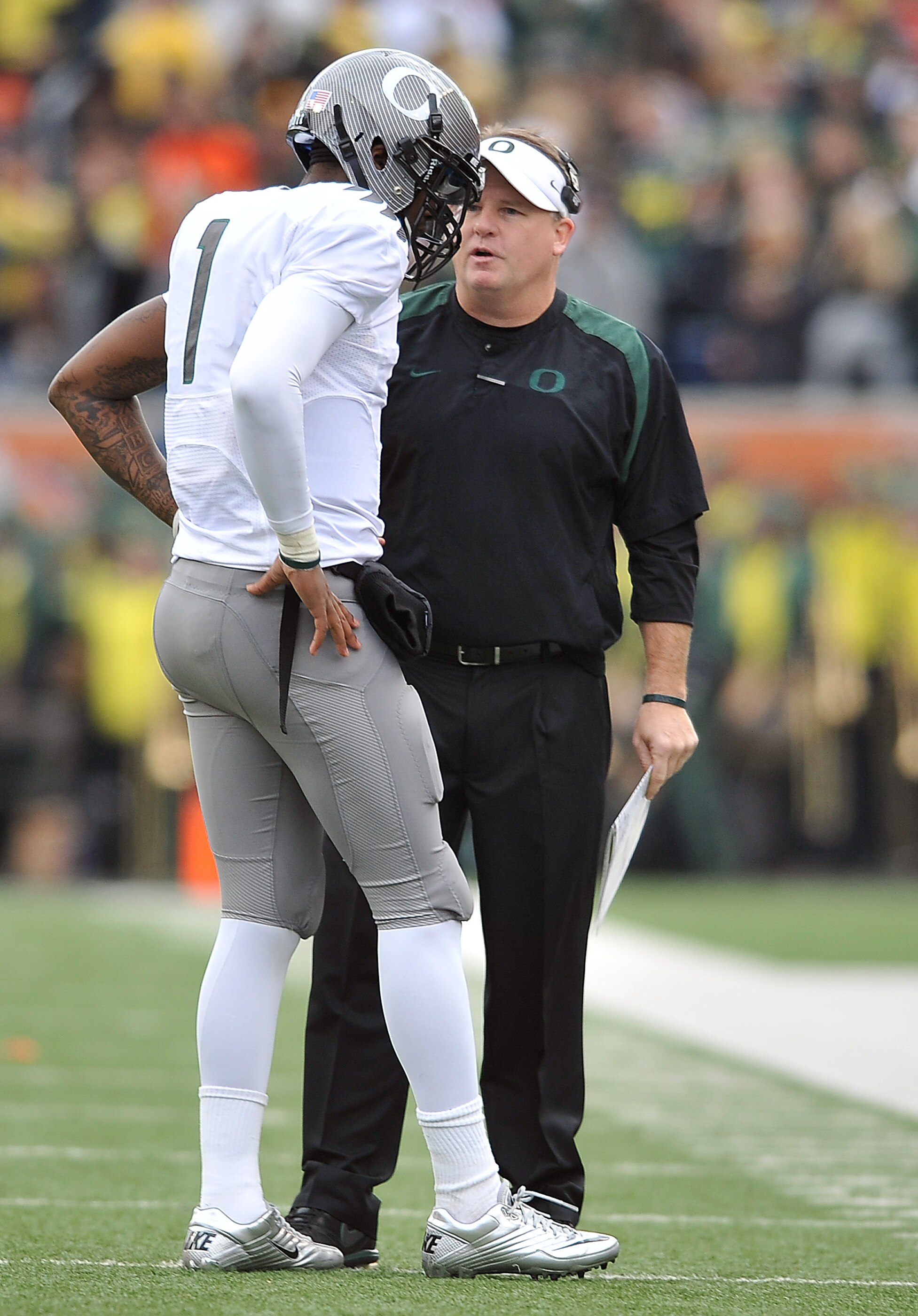 CORVALLIS, OR - DECEMBER 4: Head coach Chip Kelly speaks with quarterback Darron Thomas #1 of the Oregon Ducks in the second quarter of the game against the the Oregon State Beavers at Reser Stadium on December 4, 2010 in Corvallis, Oregon. The Ducks beat