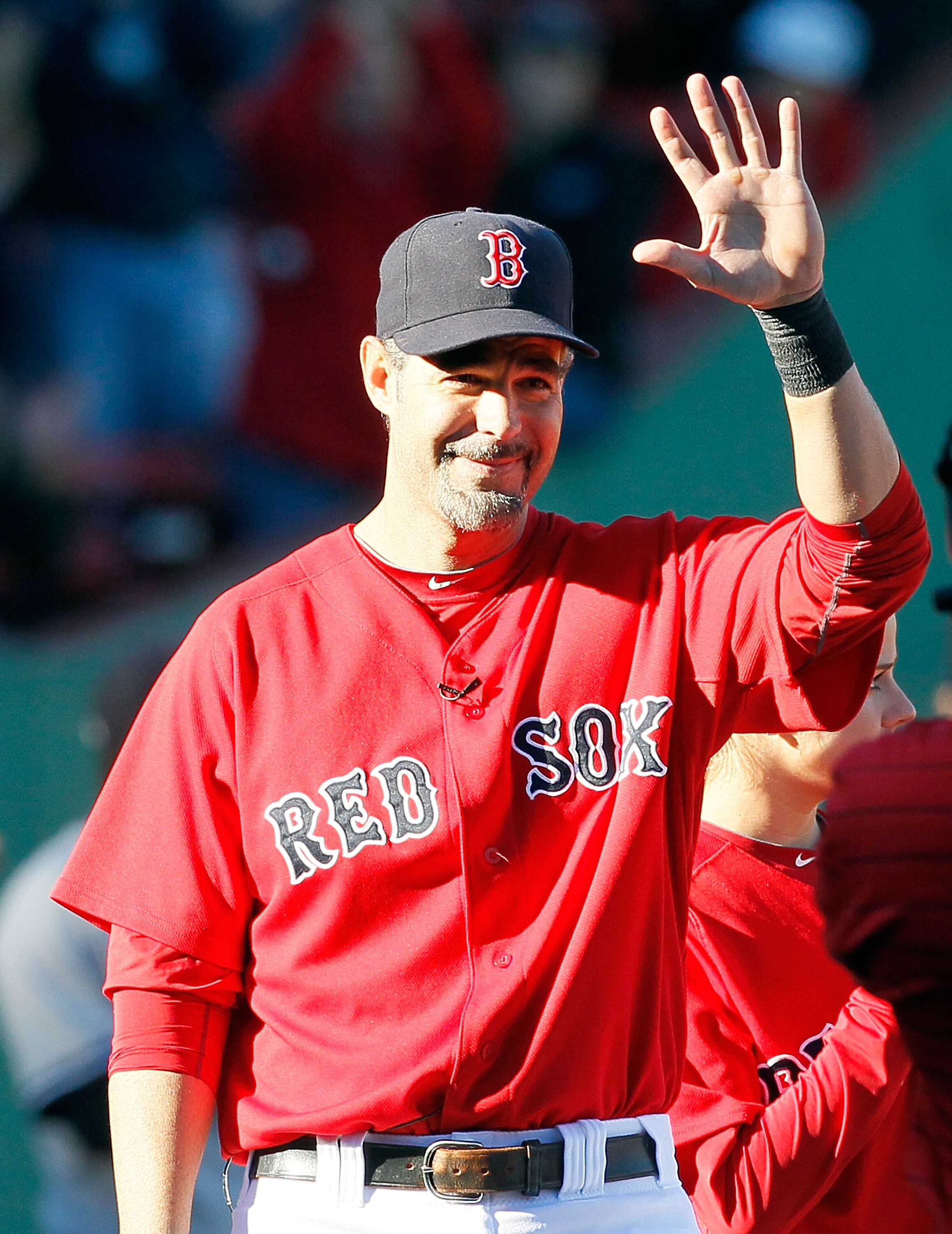 BOSTON - OCTOBER 2:  Mike Lowell #25 of the Boston Red Sox reacts to the applause of fans during a ceremony in his honor before  the first game of a doubleheader against the New York Yankees at Fenway Park October 2, 2010 in Boston, Massachusetts. Lowell