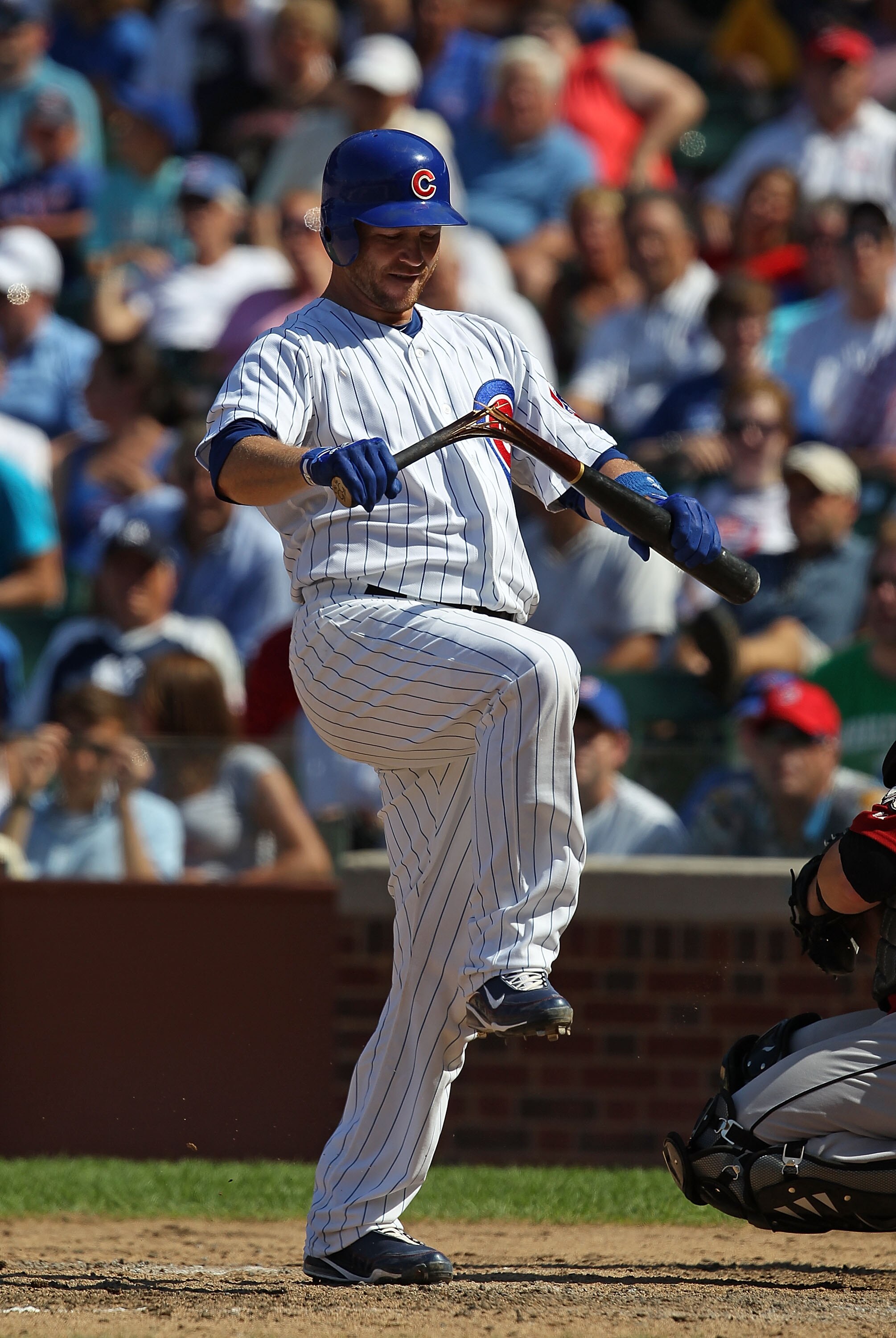 CHICAGO - JULY 21: Koyie Hill #55 of the Chicago Cubs breaks his bat over his knee after striking out trying to bunt in the 6th inning against the Houston Astros at Wrigley Field on July 21, 2010 in Chicago, Illinois. The Astros defeated the Cubs 4-3 in 1
