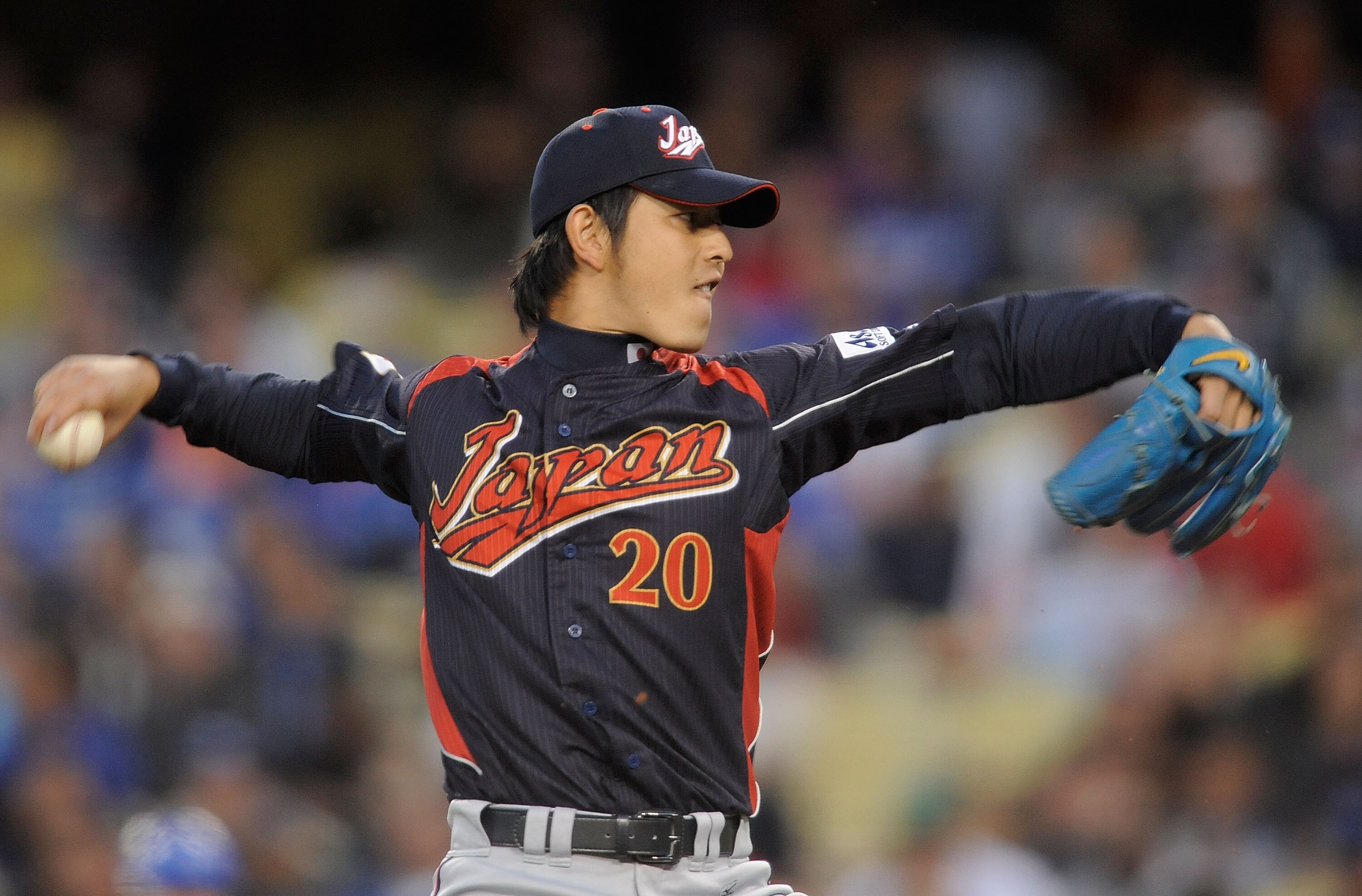 LOS ANGELES, CA - MARCH 23:  Starting pitcher Hisashi Iwakuma #20 of Japan delivers a pitch against Korea in the first inning of the finals of the 2009 World Baseball Classic on March 23, 2009 at Dodger Stadium in Los Angeles, California.  (Photo by Kevor