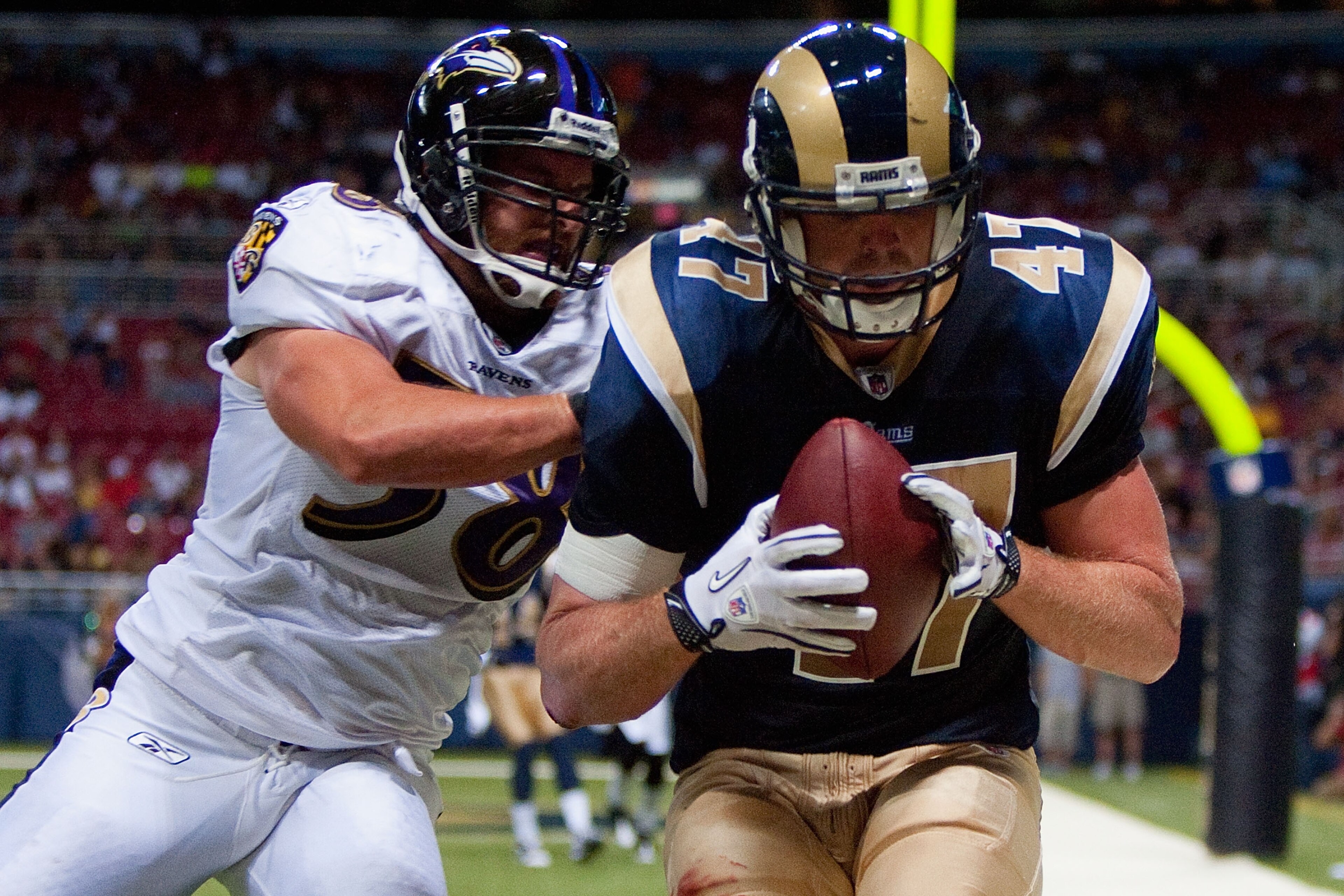 ST. LOUIS - SEPTEMBER 2: Billy Bajema #47 of the St. Louis Rams hauls in a touchdown against Jason Phillips #58 of the Baltimore Ravens during an NFL preseason game at the Edward Jones Dome on September 2, 2010 in St. Louis, Missouri.  (Photo by Dilip Vis