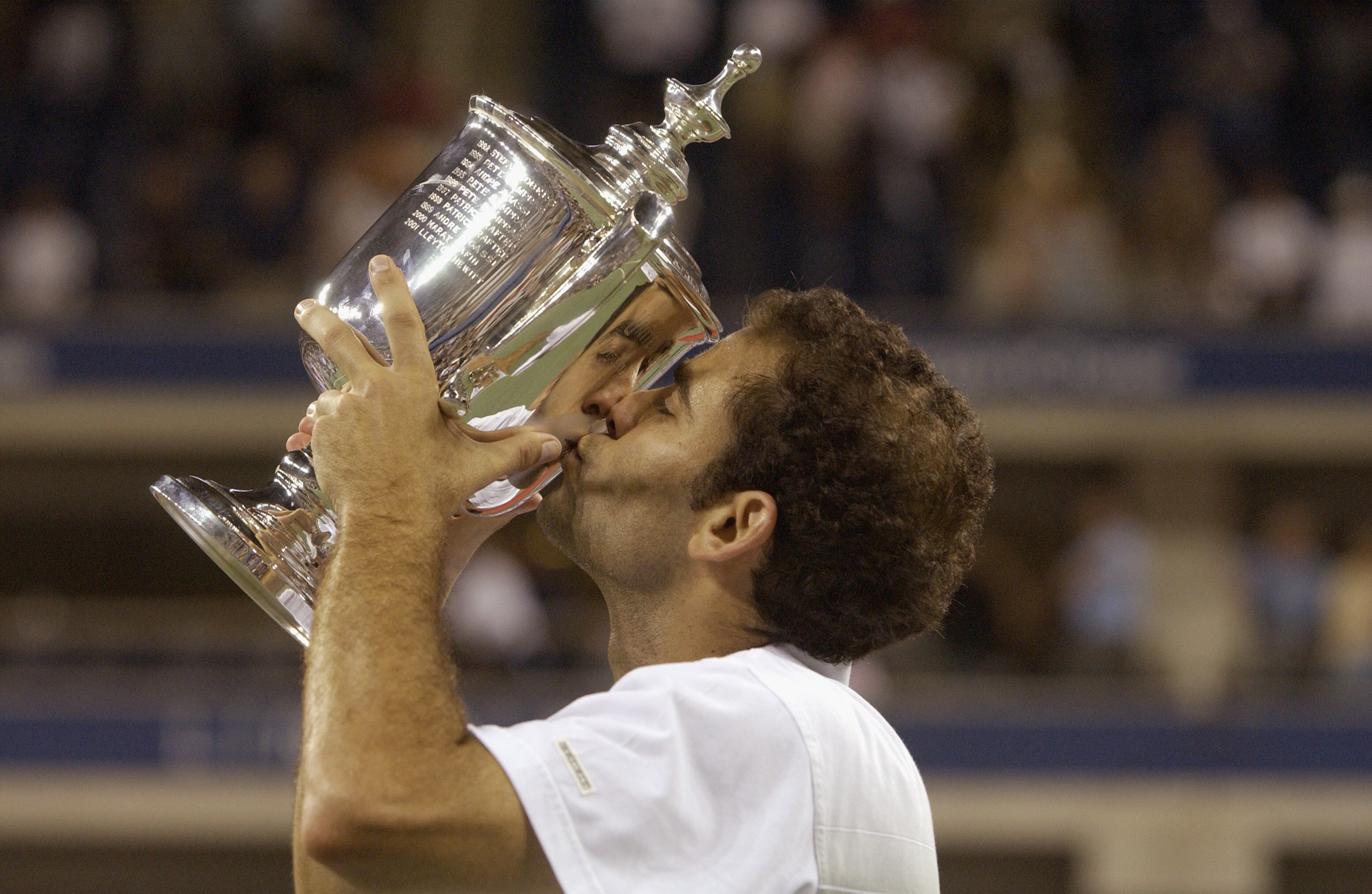 FLUSHING, NY - SEPTEMBER 8:  Pete Sampras kisses his trophy during the US Open September 8, 2002 at the USTA National Tennis Center in Flushing Meadows Corona Park in Flushing, New York.  (Photo by Ezra Shaw/Getty Images)