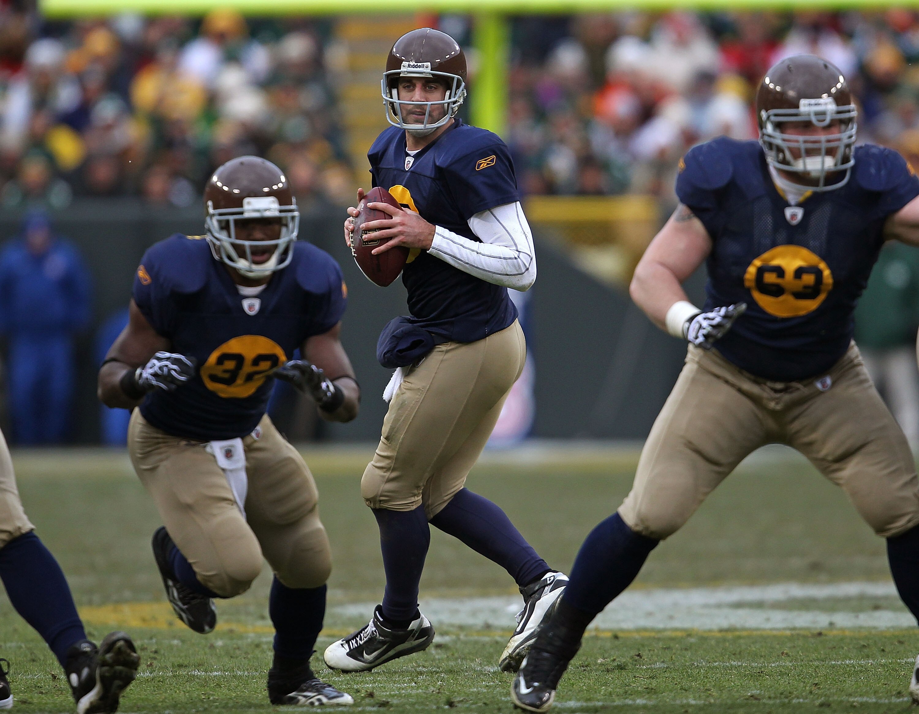 GREEN BAY, WI - DECEMBER 05: Aaron Rodgers #12 of the Green Bay Packers drops back to pass as Brandon Jackson #23 runs a route and Scott Wells #63 moves to block against the San Francisco 49ers at Lambeau Field on December 5, 2010 in Green Bay, Wisconsin.
