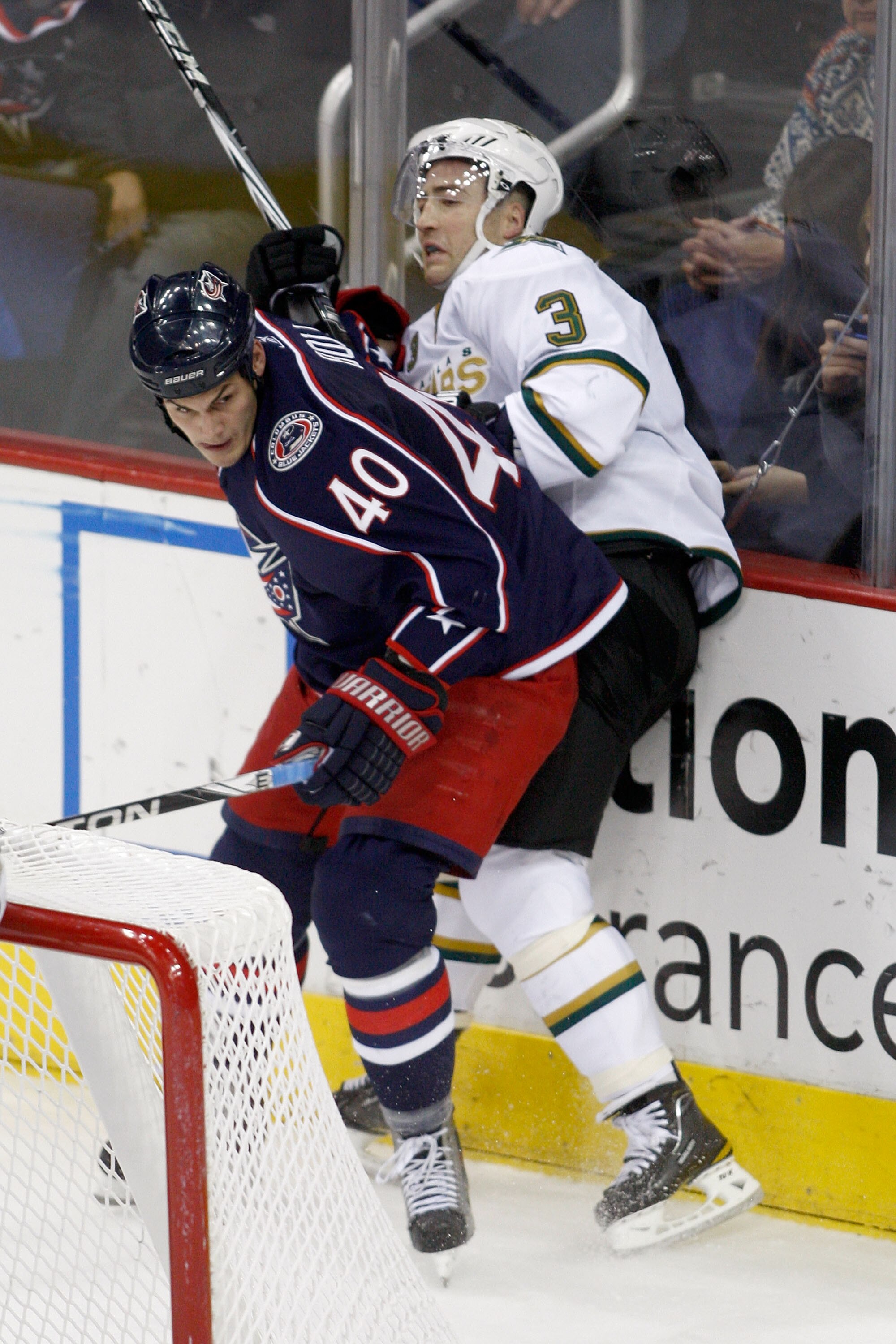 COLUMBUS, OH - DECEMBER 6:  Jared Boll #40 of the Columbus Blue Jackets checks Stephane Robidas #3 of the Dallas Stars during the third period on December 6, 2010 at Nationwide Arena in Columbus, Ohio.  Columbus defeated Dallas 3-2 in a shootout.  (Photo