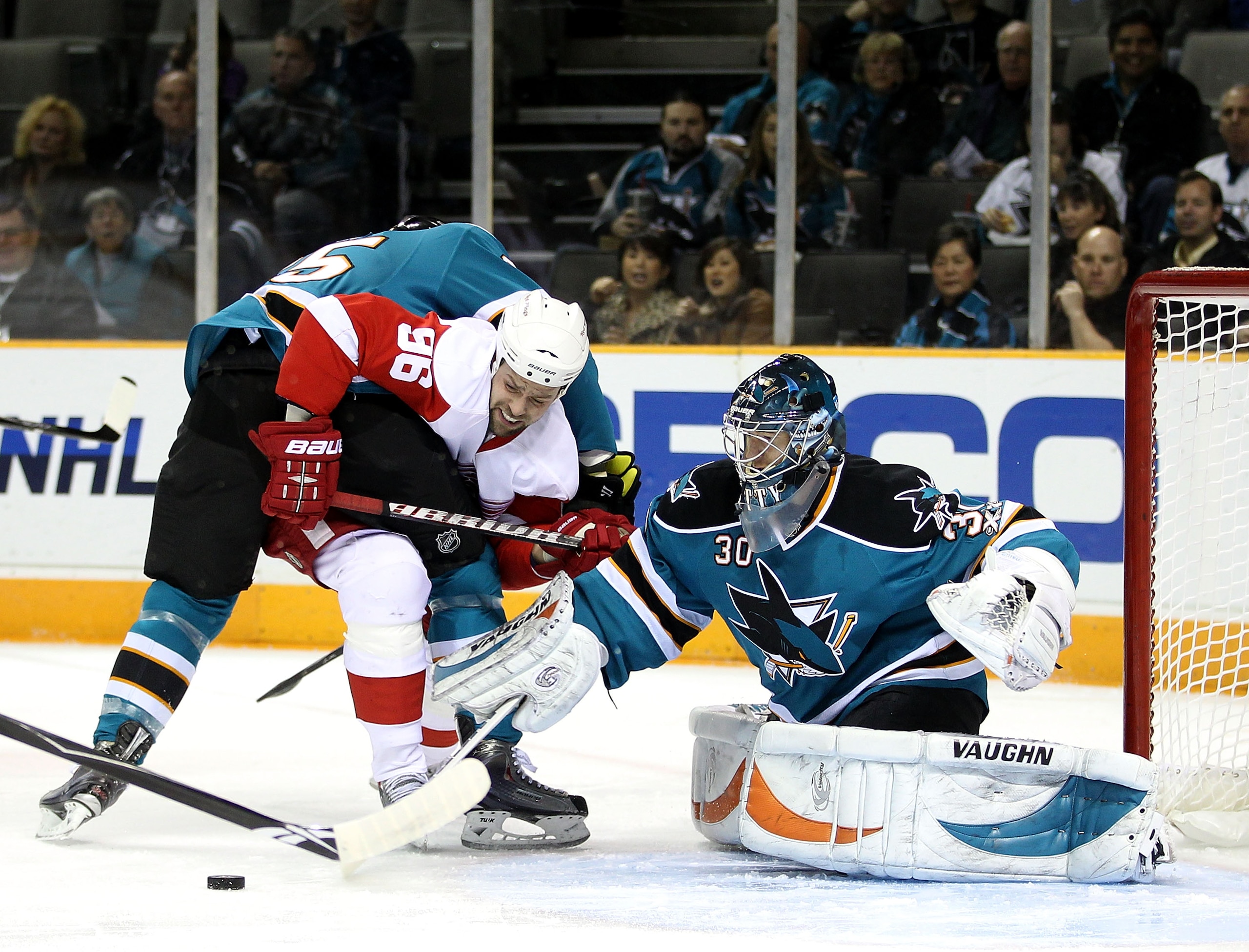 SAN JOSE, CA - NOVEMBER 30:  Tomas Holmstrom #96 of the Detroit Red Wings tries to score on Derek Joslin #65 of the San Jose Sharks and Antero Niittymaki #30 of the San Jose Sharks at HP Pavilion on November 30, 2010 in San Jose, California.  (Photo by Ez