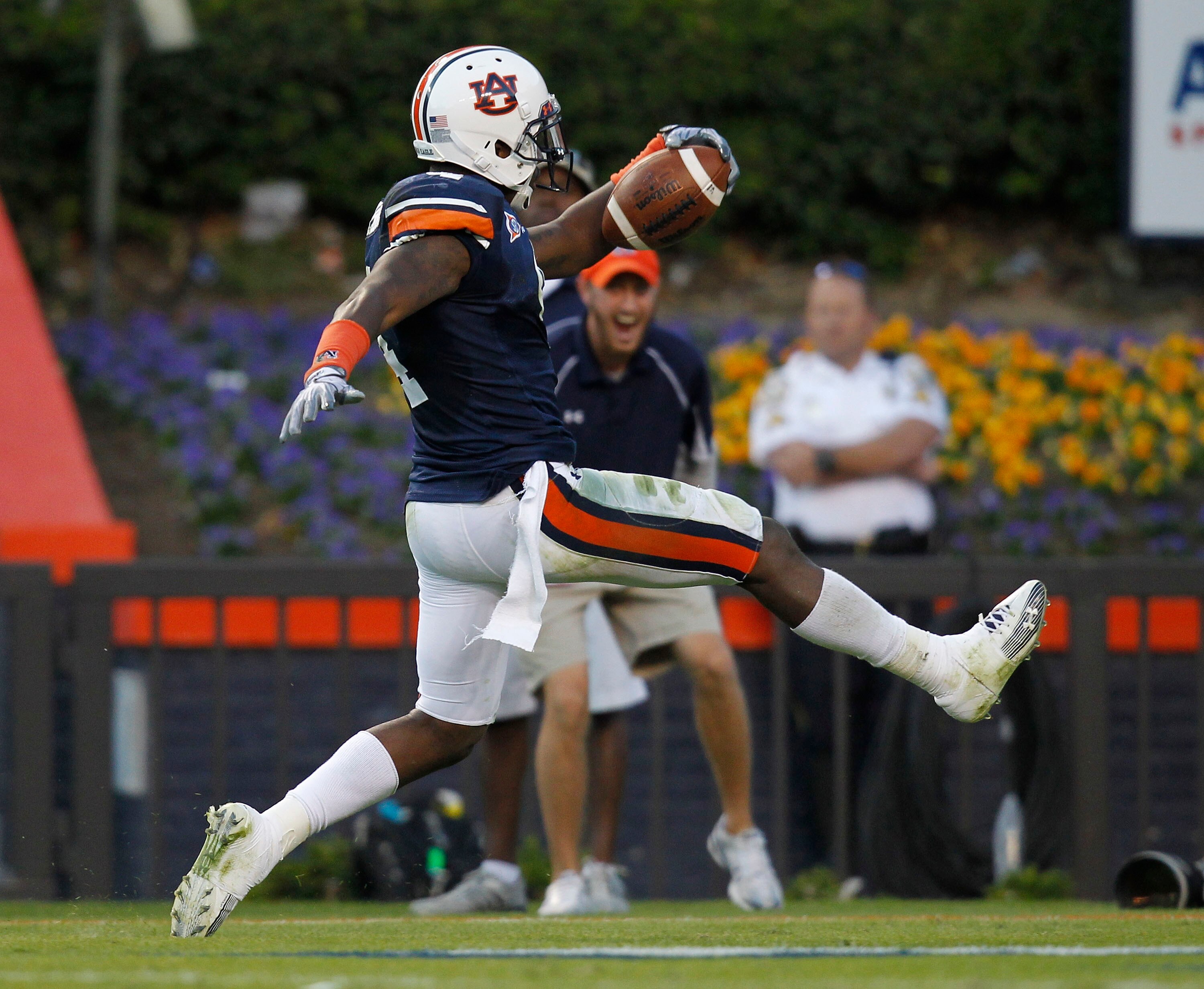 AUBURN, AL - OCTOBER 16:  Safety Zac Etheridge #4 of the Auburn Tigers brings a fumble back for a touchdown during the game against the Arkansas Razorbacks at Jordan-Hare Stadium on October 16, 2010 in Auburn, Alabama.  The Tigers beat the Razorbacks 65-4