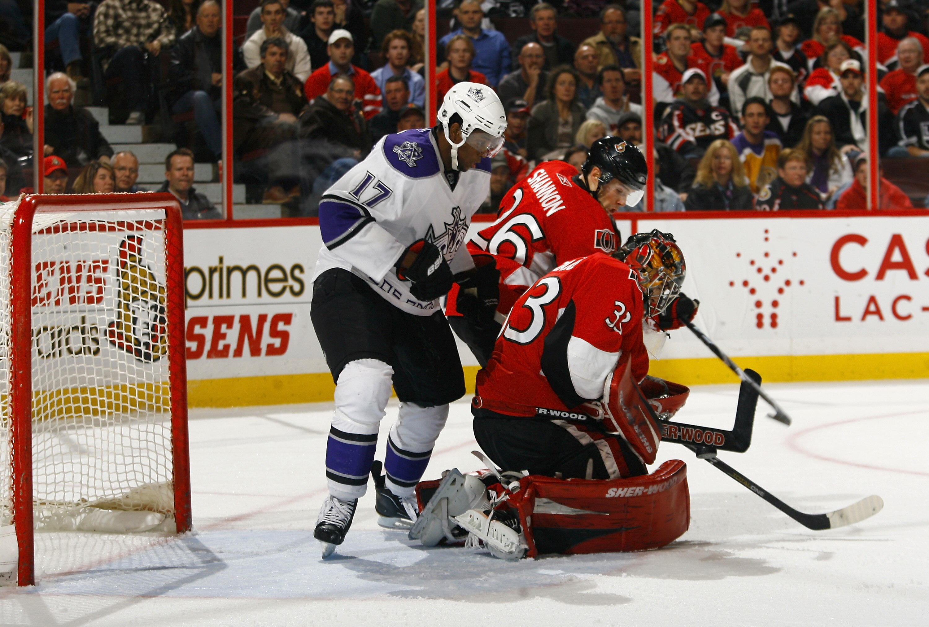 OTTAWA, ON - NOVEMBER 22:  Wayne Simmonds #17 of the Los Angeles Kings battles with Ryan Shannon #26 of the Ottawa Senators in the crease while teammate Pascal Leclaire #33 makes a save down low during a game at Scotiabank Place on November 22, 2010 in Ot