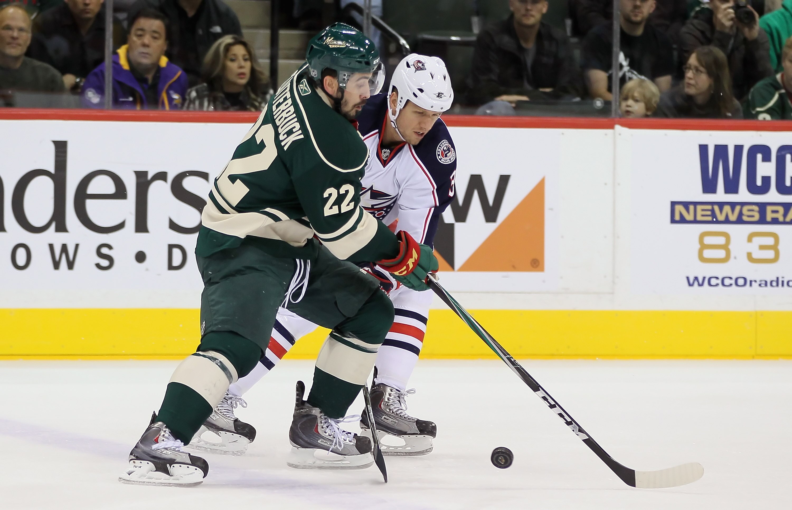 ST PAUL, MN - OCTOBER 16:  Cal Clutterbuck #22 of the Minnesota Wild and Marc Methot #3 of the Columbus Blue Jackets battle for the puck at Xcel Energy Center on October 16, 2010 in St Paul, Minnesota.  (Photo by Jeff Gross/Getty Images)
