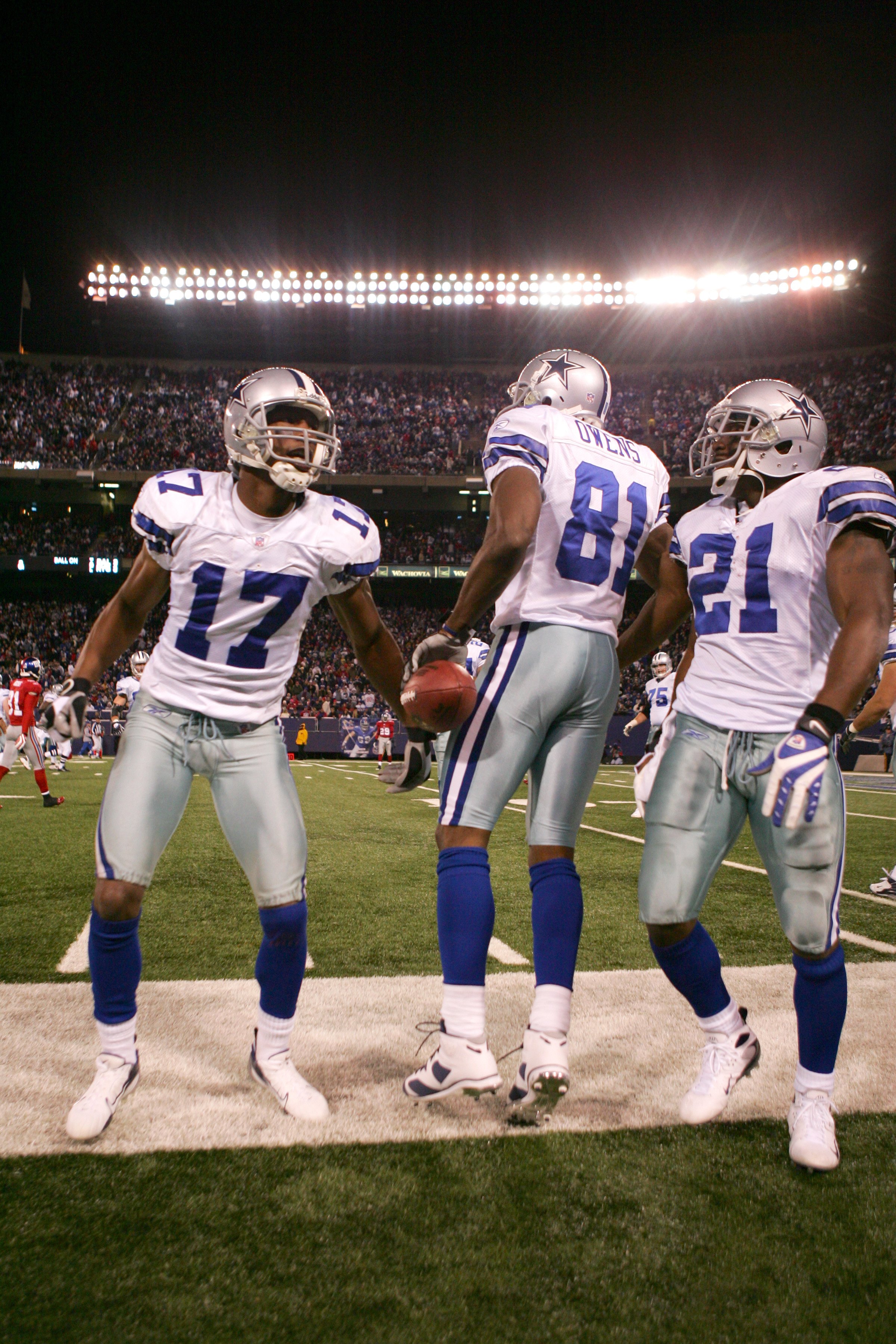 NEW JERSEY - NOVEMBER 11, 2007:  Sam Hurd #17, Terrell Owens #81, and Julius Jones #21 of the Dallas Cowboys looks on from the sidelines during the NFL game against the New York Giants at Giants Stadium on November 11, 2007 in Rutherford, New Jersey. (Pho