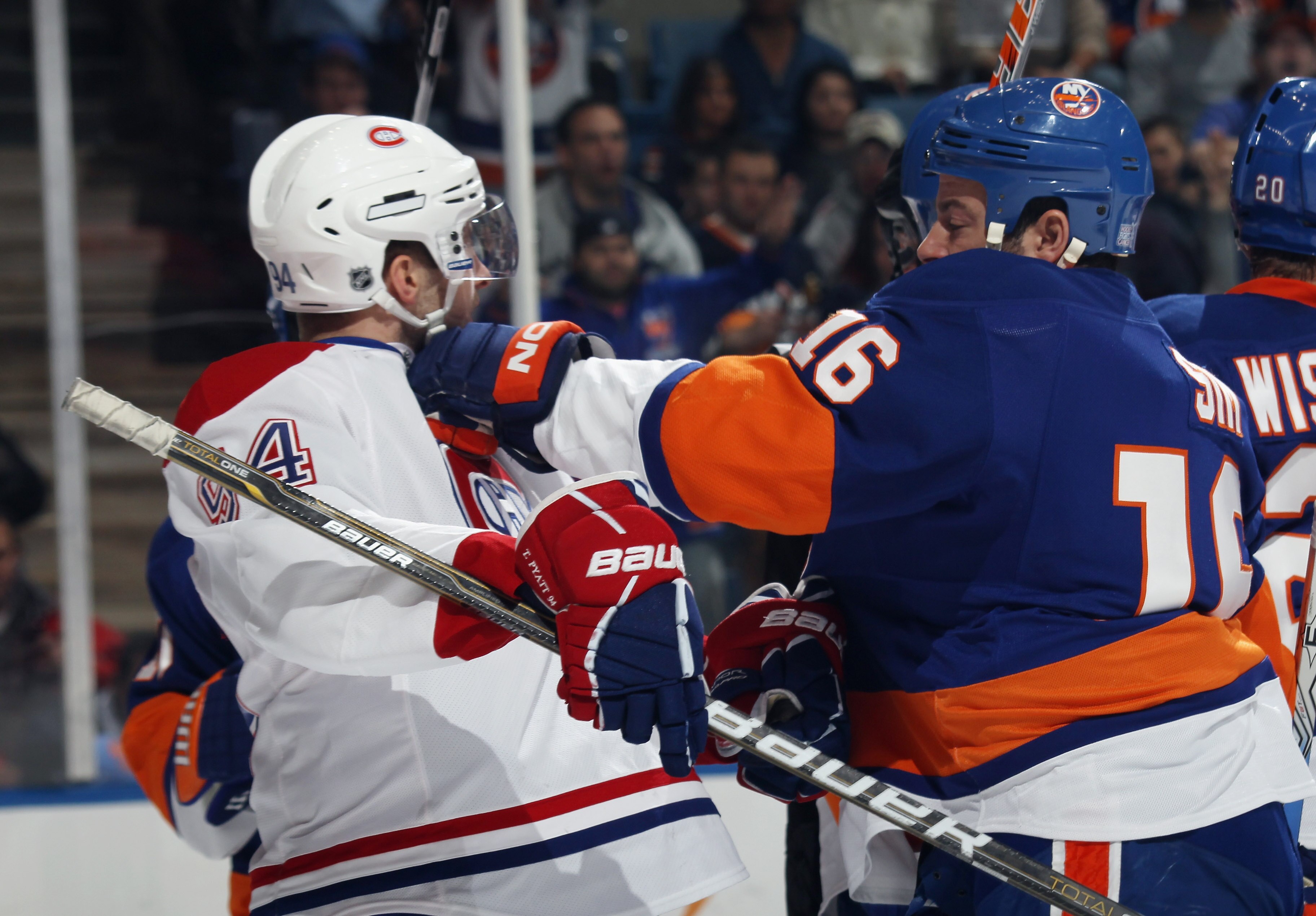 UNIONDALE, NY - OCTOBER 29: Tom Pyatt #94 of the Montreal Canadiens is hit by Jon Sim #16 of the New York Islanders at the Nassau Coliseum on October 29, 2010 in Uniondale, New York. (Photo by Bruce Bennett/Getty Images)