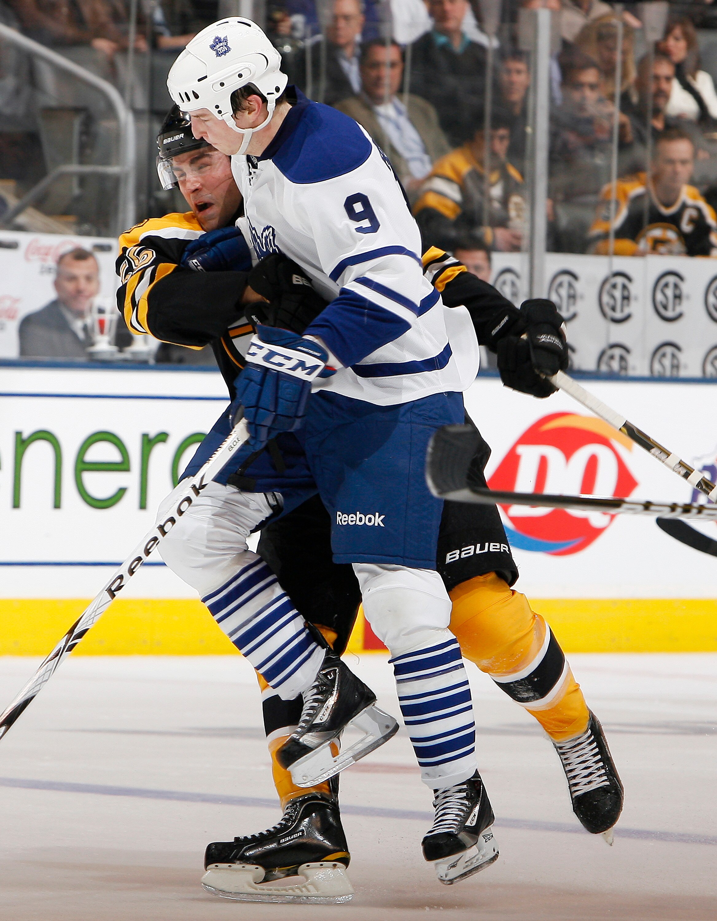 TORONTO, CANADA - DECEMBER 4: Colby Armstrong #9 of the Toronto Maple Leafs runs into Blake Wheeler #26 of the Boston Bruins during game action at the Air Canada Centre December 4, 2010 in Toronto, Ontario, Canada. (Photo by Abelimages / Getty Images)
