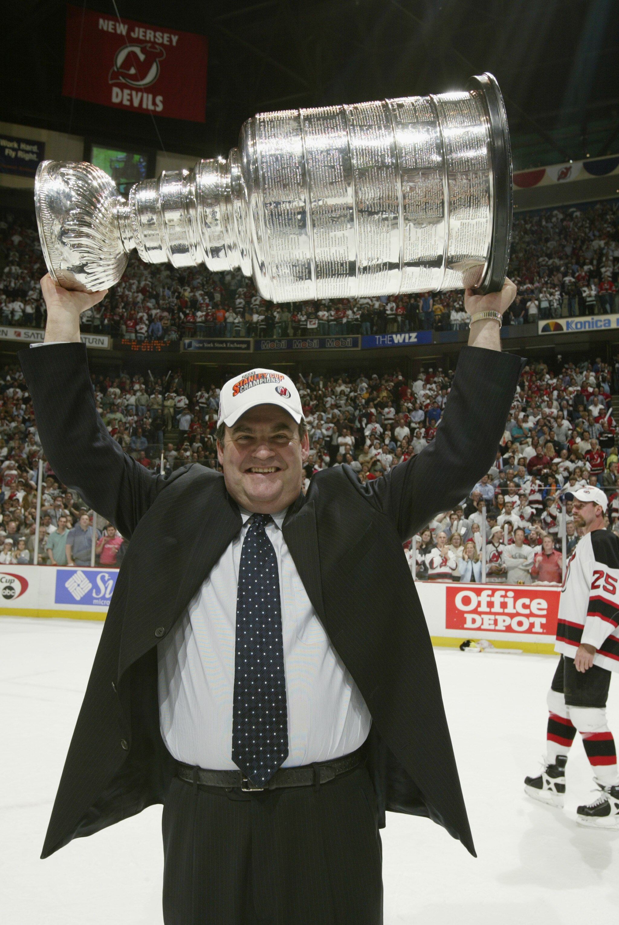 EAST RUTHERFORD, NJ - JUNE 9:  Head coach Pat Burns of the New Jersey Devils holds up the Stanley Cup after defeating the Mighty Ducks of Anaheim 3-0 in game seven of the 2003 Stanley Cup Finals at Continental Airlines Arena on June 9, 2003 in East Ruther