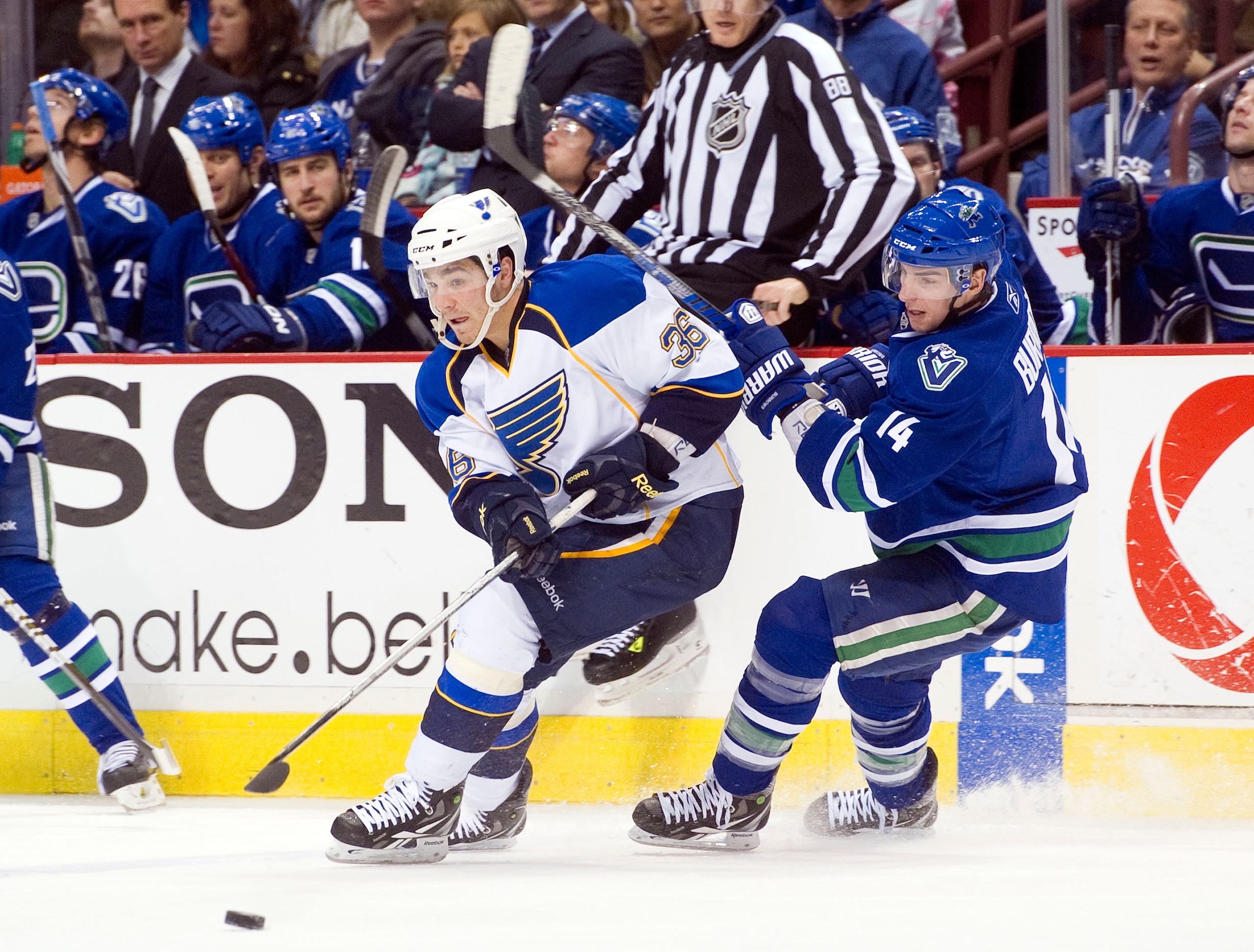 VANCOUVER, CANADA - DECEMBER 5: Alexandre Burrows #14 of the Vancouver Canucks checks Matt D'Agostini #36 of the St Louis Blues off the puck during the third period in NHL action on December 05, 2010 at Rogers Arena in Vancouver, BC, Canada.  (Photo by Ri