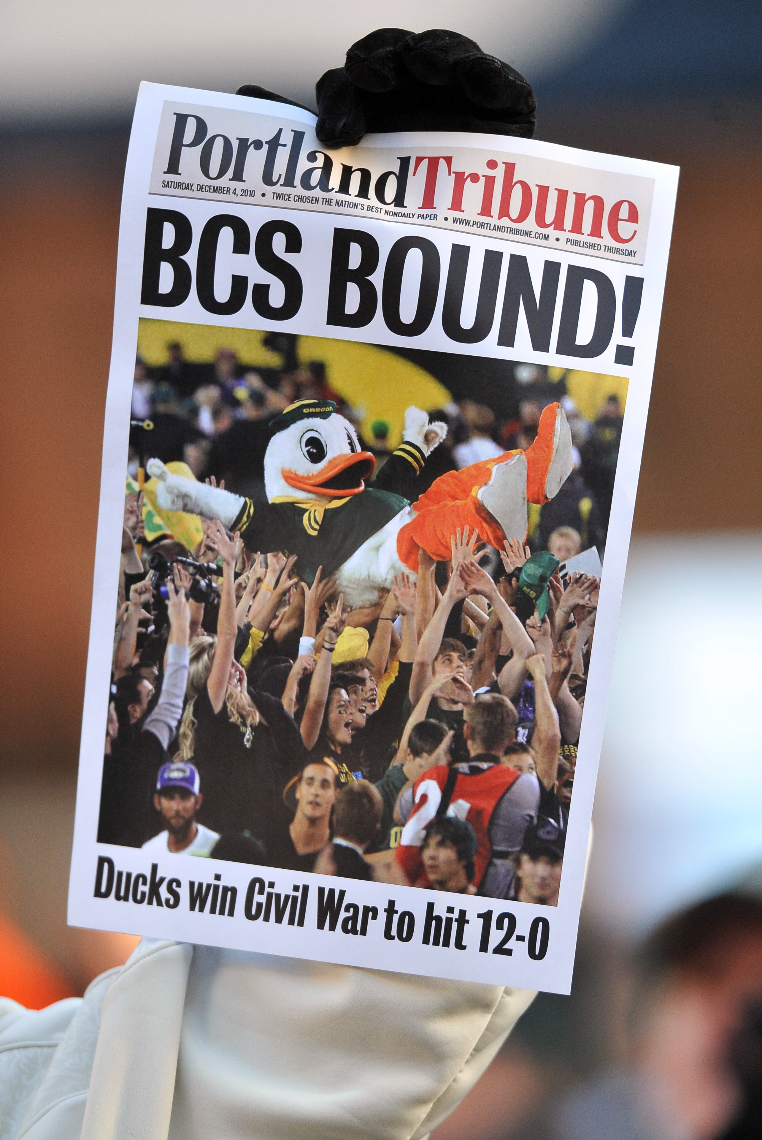 CORVALLIS, OR - DECEMBER 4: A fan holds up a copy of a mock front page after game between the Oregon Ducks and the Oregon State Beavers at Reser Stadium on December 4, 2010 in Corvallis, Oregon. The Ducks beat the Beavers 37-20 to likely go on to the BCS
