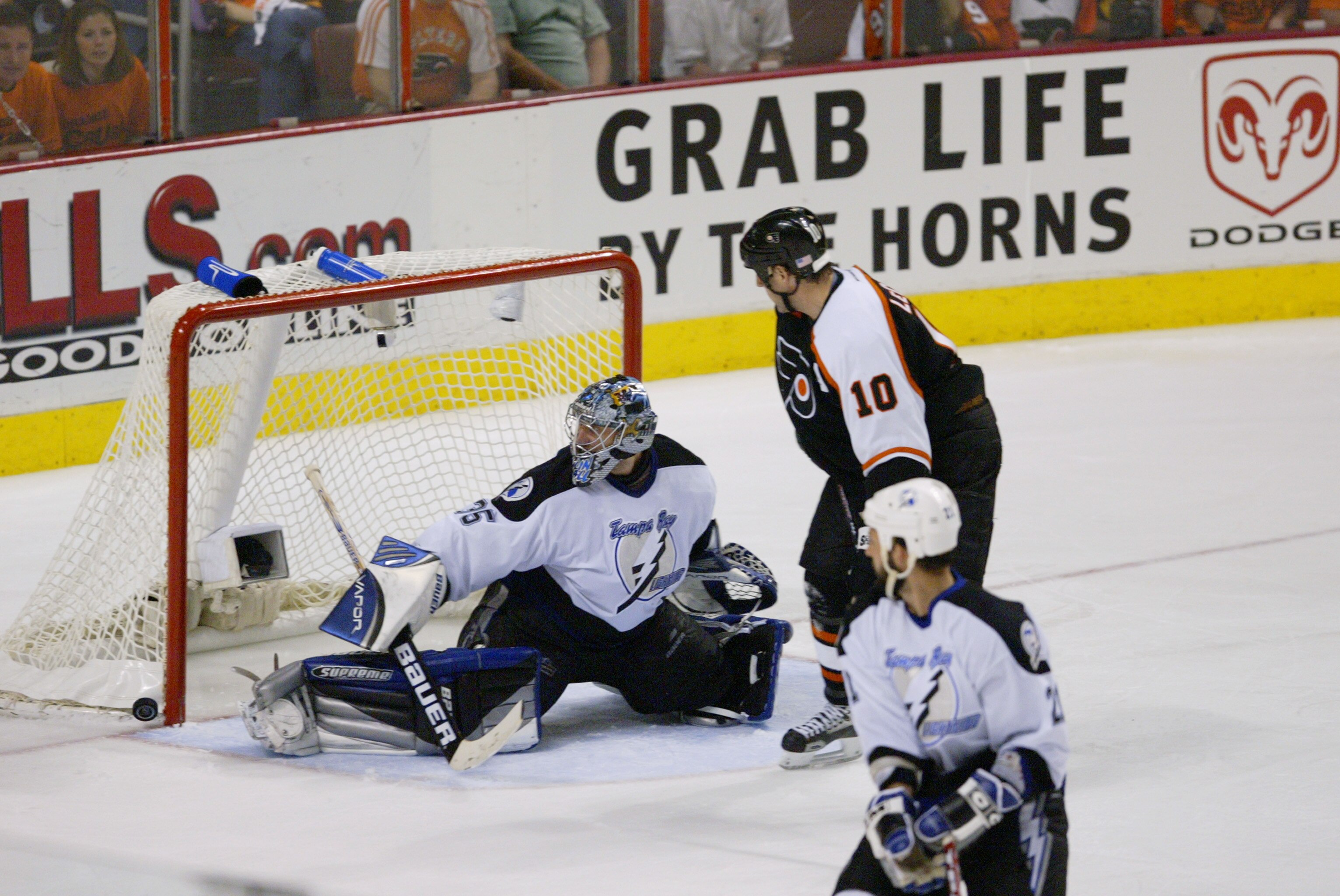 PHILADELPHIA - MAY 15:  Goaltender Nikolai Khabibulin #35 of the Tampa Bay Lightning attempts to stop a shot on goal as left wing John LeClair #10 of the Philadelphia Flyers applies pressure in Game four of the 2004 NHL Eastern Conference Finals at the Wa