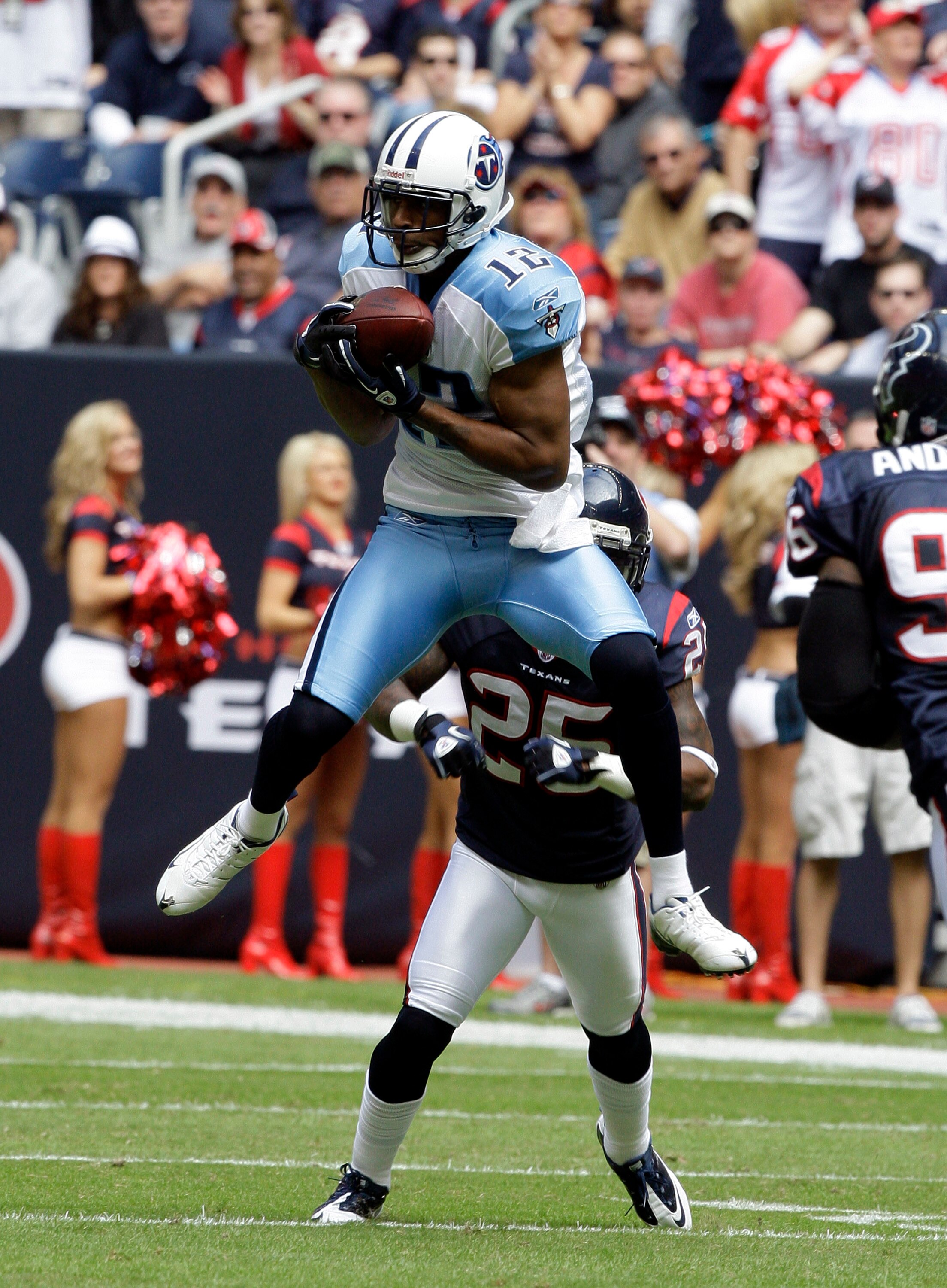 HOUSTON - NOVEMBER 28:  Wide receive Justin Gage #12 of the Tennessee Titans makes a catch in front of cornerback Kareem Jackson in the first quarter at Reliant Stadium on November 28, 2010 in Houston, Texas.  (Photo by Bob Levey/Getty Images)