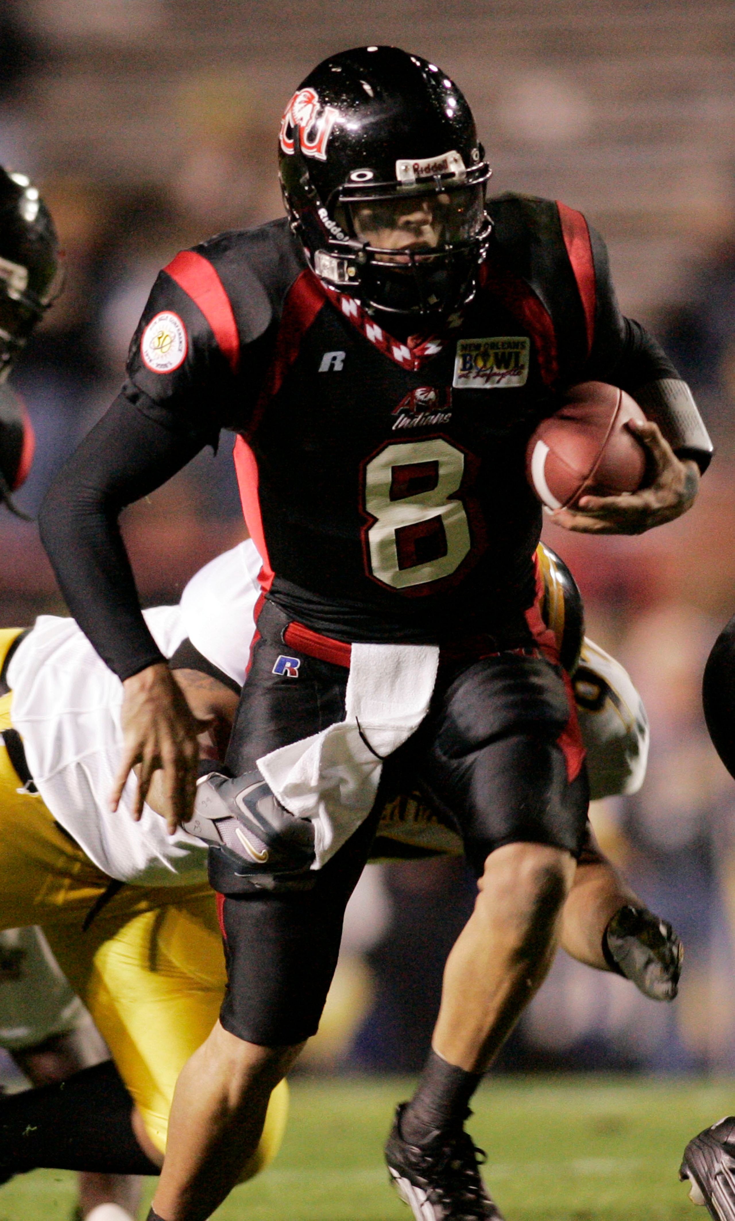 LAFAYETTE, LA - DECEMBER 20:  Quarterback Nick Noce #8 of Arkansas State avoids a tackle by Reggie Green #97 of Southern Miss during The New Orleans Bowl on December 20, 2005 at Cajun Field in Lafayette, Louisiana.  The New Orleans Bowl was moved to Lafay