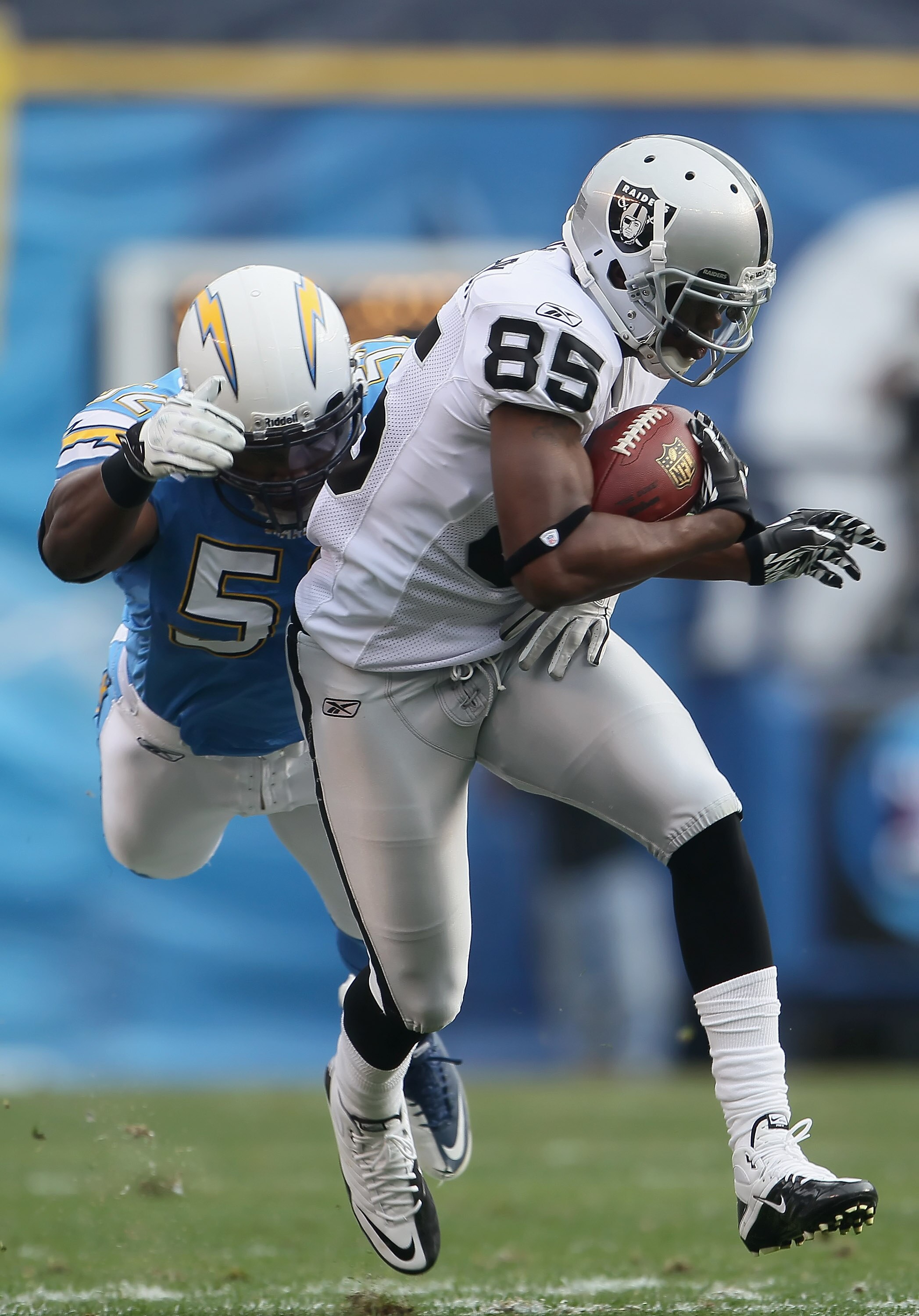 SAN DIEGO - DECEMBER 05:  Darrius Heyward-Bey #85 of the Oakland Raiders is tackled by Larry English #52 of the San Diego Chargers in the second quarter at Qualcomm Stadium on December 5, 2010 in San Diego, California. The Raiders defeated the Chargers 28