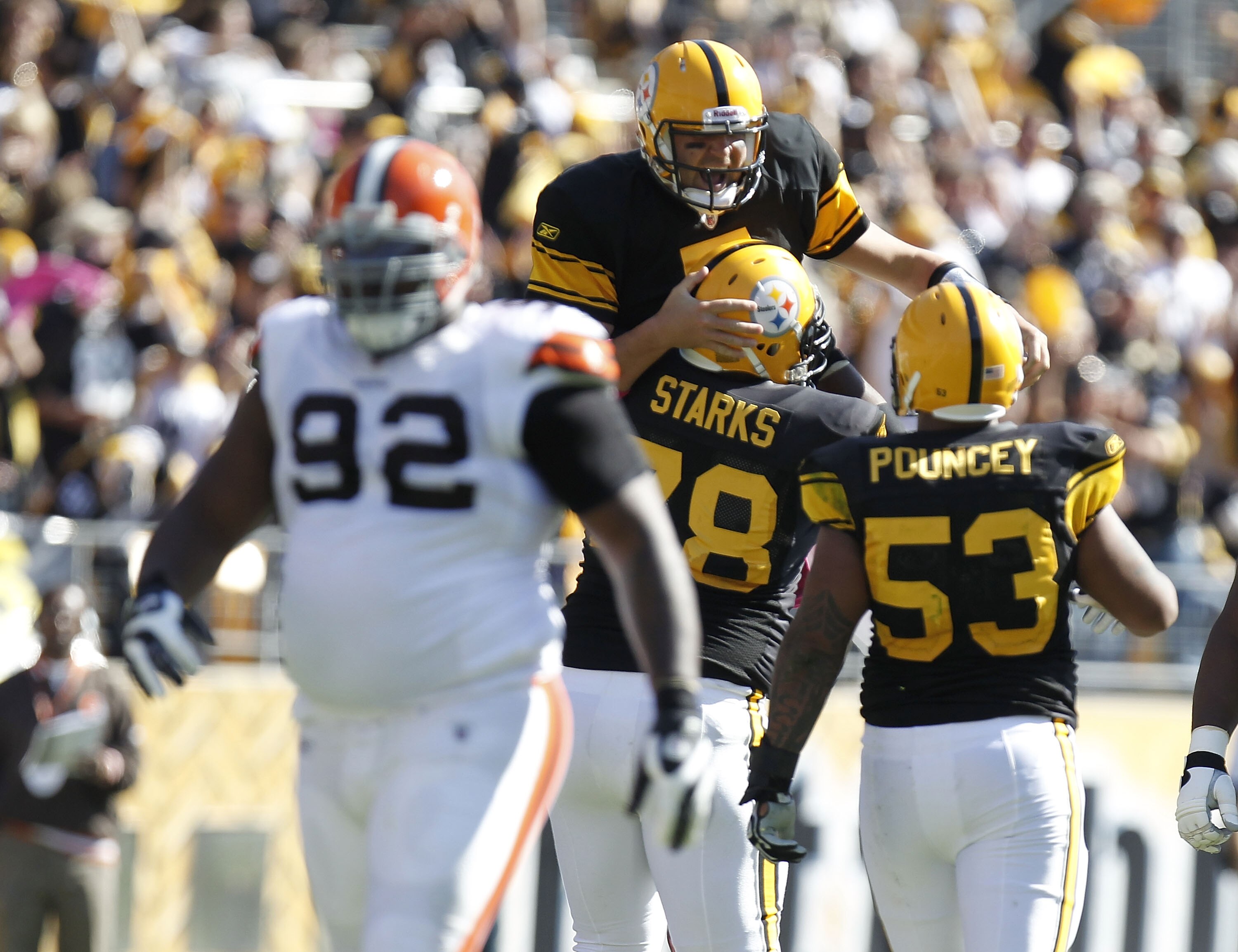PITTSBURGH - OCTOBER 17:  Ben Roethlisberger #7 of the Pittsburgh Steelers celebrates a second quarter touchdown pass with Max Starks #78 and Maurkice Pouncey #53 behind Shaun Rogers #92 of the Cleveland Browns on October 17, 2010 at Heinz Field in Pittsb