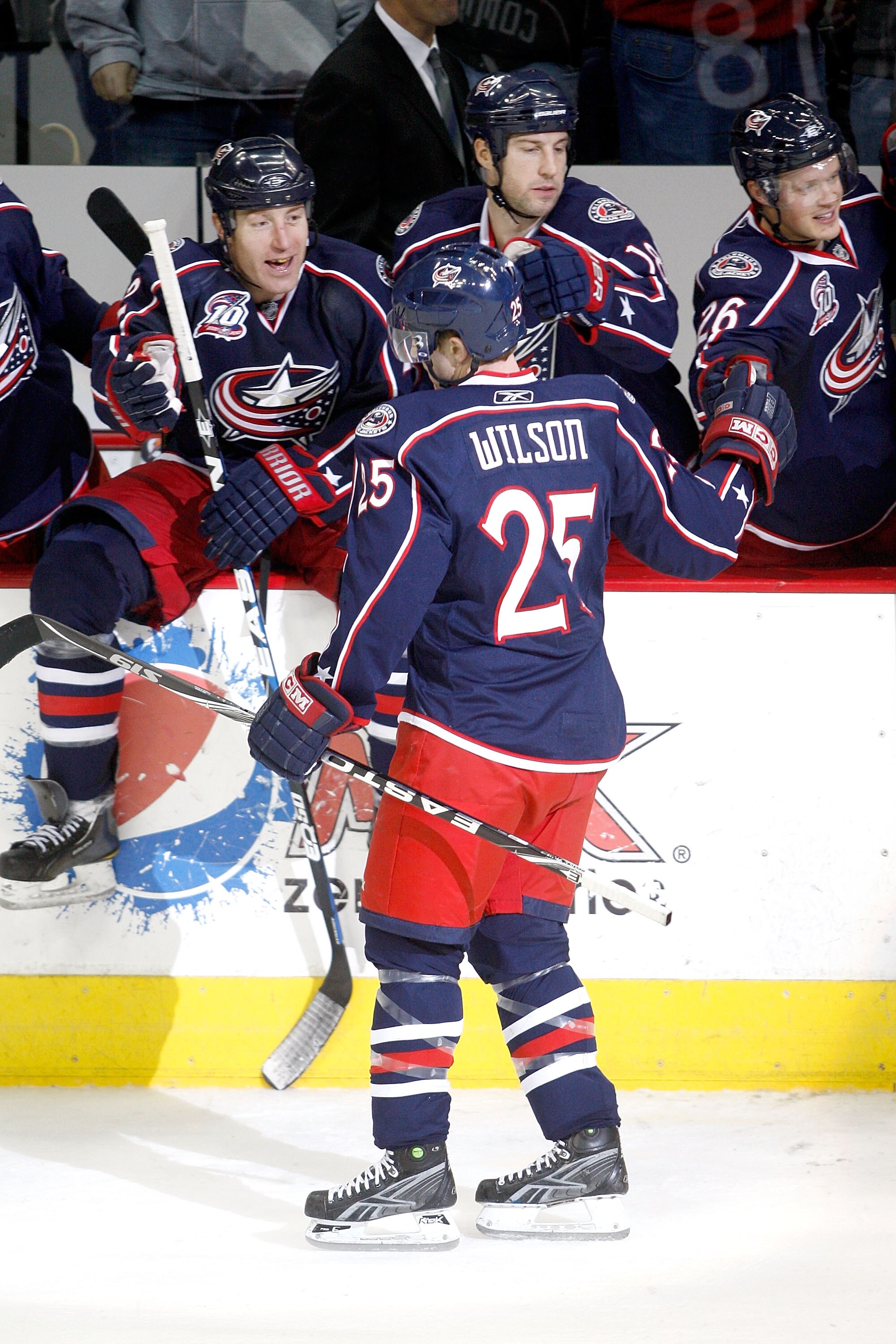 COLUMBUS, OH - DECEMBER 6:  Kyle Wilson #25 of the Columbus Blue Jackets is congratulated by his teammates after scoring the game winning goal against the Dallas Stars in a shootout on December 6, 2010 at Nationwide Arena in Columbus, Ohio.  Columbus defe