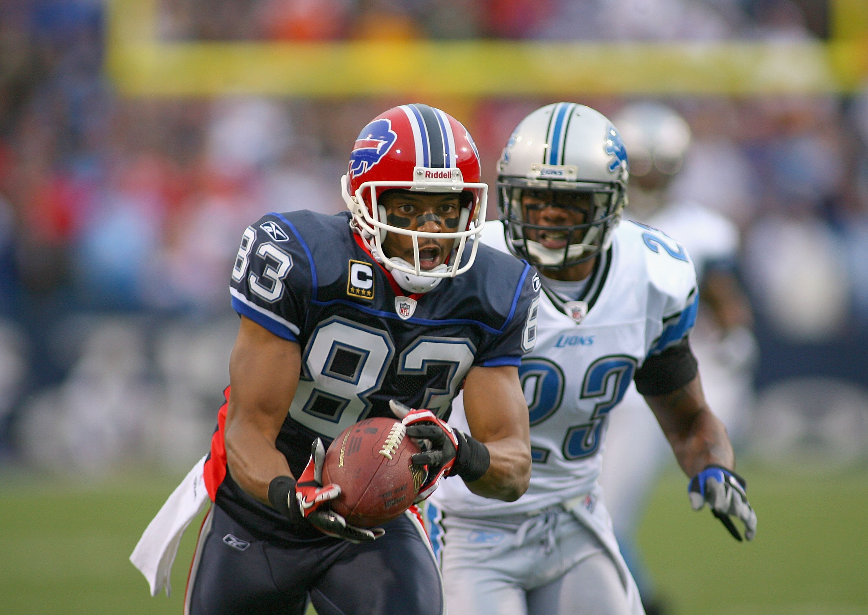 ORCHARD PARK, NY - NOVEMBER 14:  Lee Evans #83  of the Buffalo Bills makes a finger tip catch against Chris Houston #23 of the Detroit Lions at Ralph Wilson Stadium on November 14, 2010 in Orchard Park, New York. The Bills won 14-12. (Photo by Rick Stewar