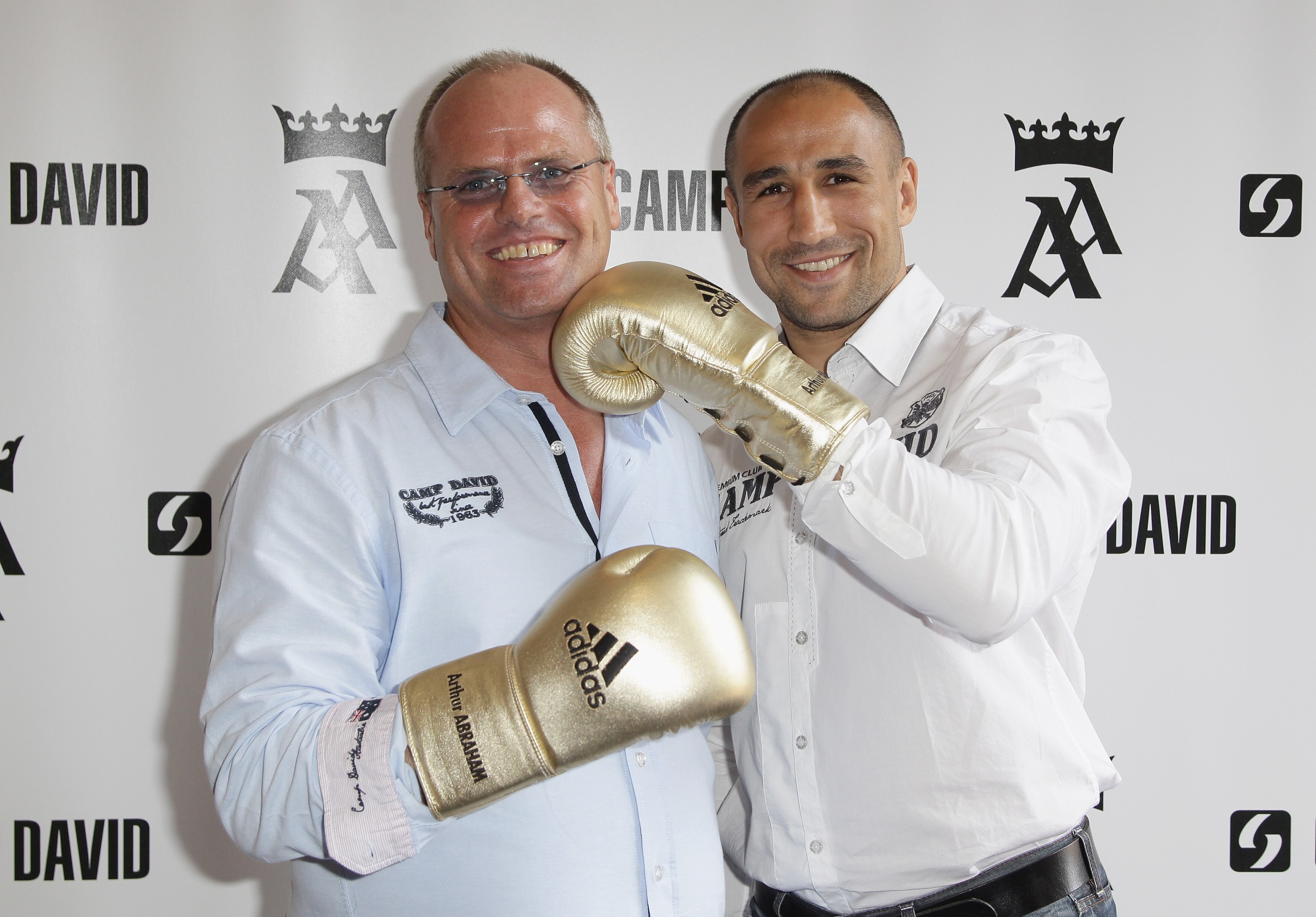 BERLIN - SEPTEMBER 16:  (L-R) Thomas Finkbeiner, CEO of Camp David and boxer Arthur Abraham pose during a press conference on September 16, 2010 in Berlin, Germany. Abraham signed a co-operation with German retail clothes company Camp David.  (Photo by An
