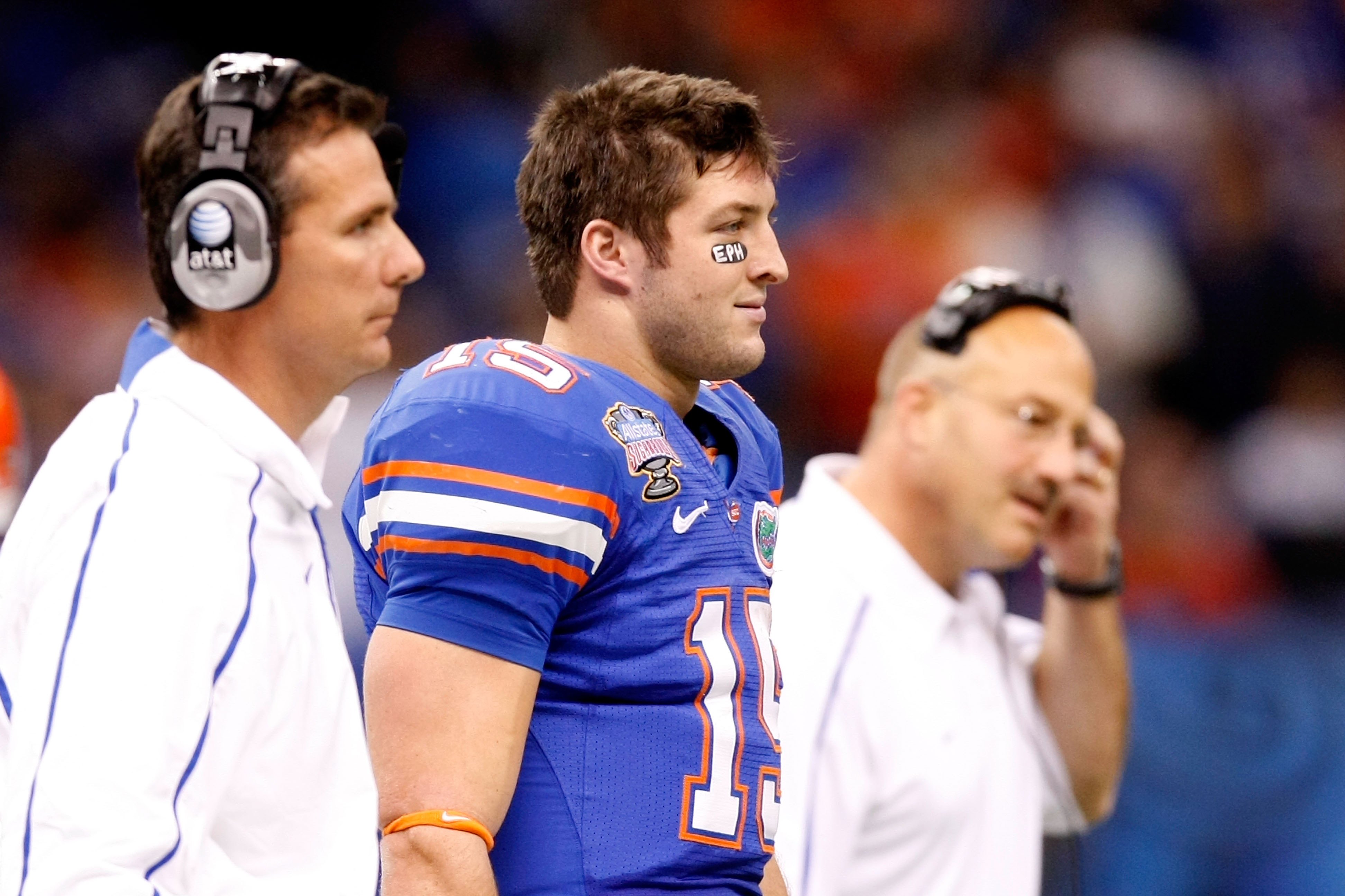 NEW ORLEANS - JANUARY 01:  (L-R) Head Coach Urban Meyer Tim Tebow #15 and Offensive coordinator and interim head coach Steve Addazio of the Florida Gators watches from the sidelines during the Allstate Sugar Bowl against the Cincinnati Bearcats at the Lou