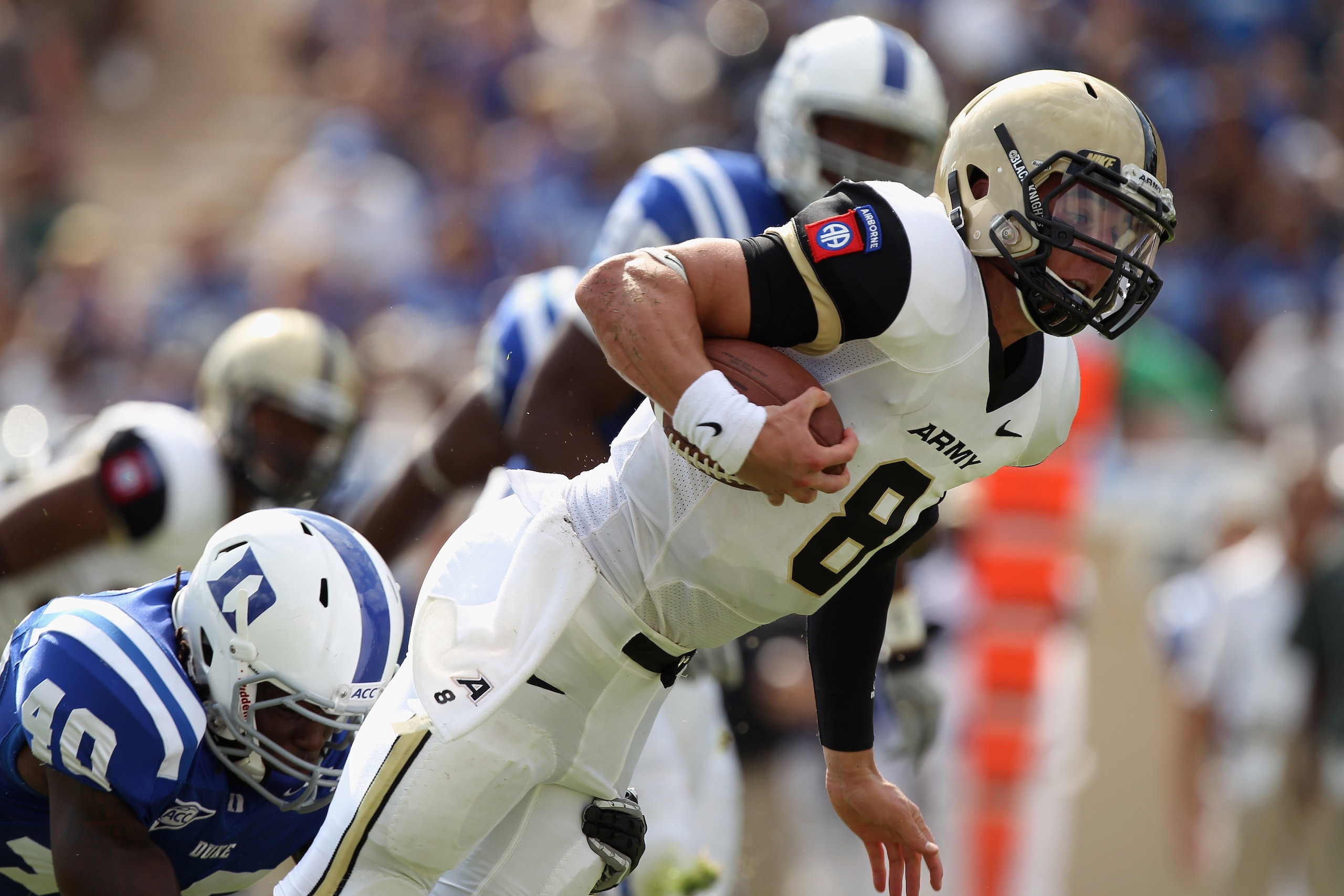 DURHAM, NC - SEPTEMBER 25:  Trent Steelman #8 of the Army Black Knights is tackled from behind by Matt Daniels #40 of the Duke Blue Devils at Wallace Wade Stadium on September 25, 2010 in Durham, North Carolina.  (Photo by Streeter Lecka/Getty Images)
