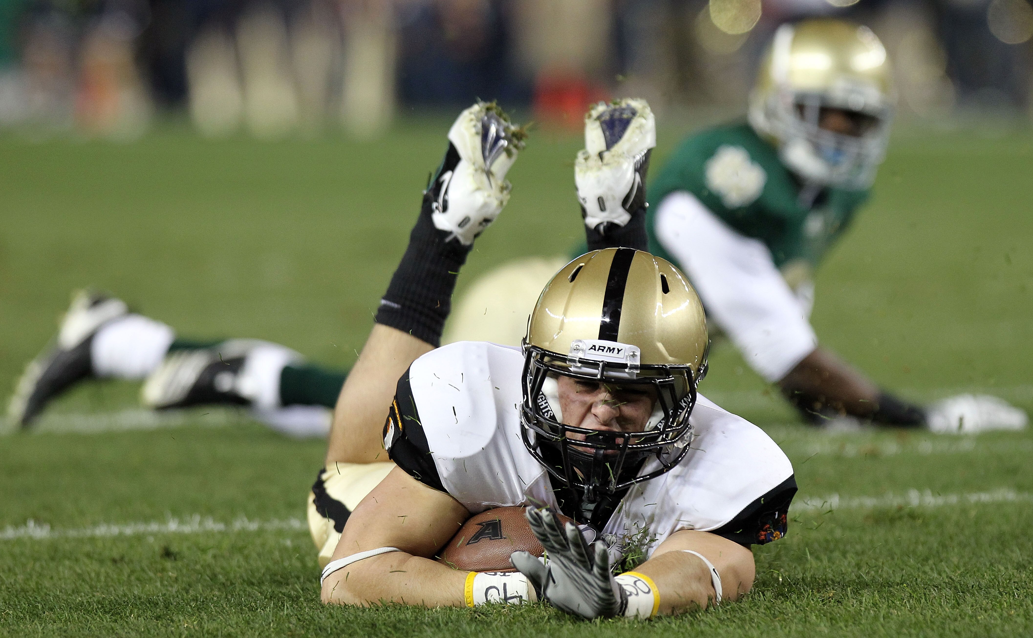 NEW YORK - NOVEMBER 20: Jonathan Crucitti #36 of the Army Black Knights falls to the ground against the Notre Dame Fighting Irish at Yankee Stadium on November 20, 2010 in the Bronx borough of New York City.  (Photo by Nick Laham/Getty Images)