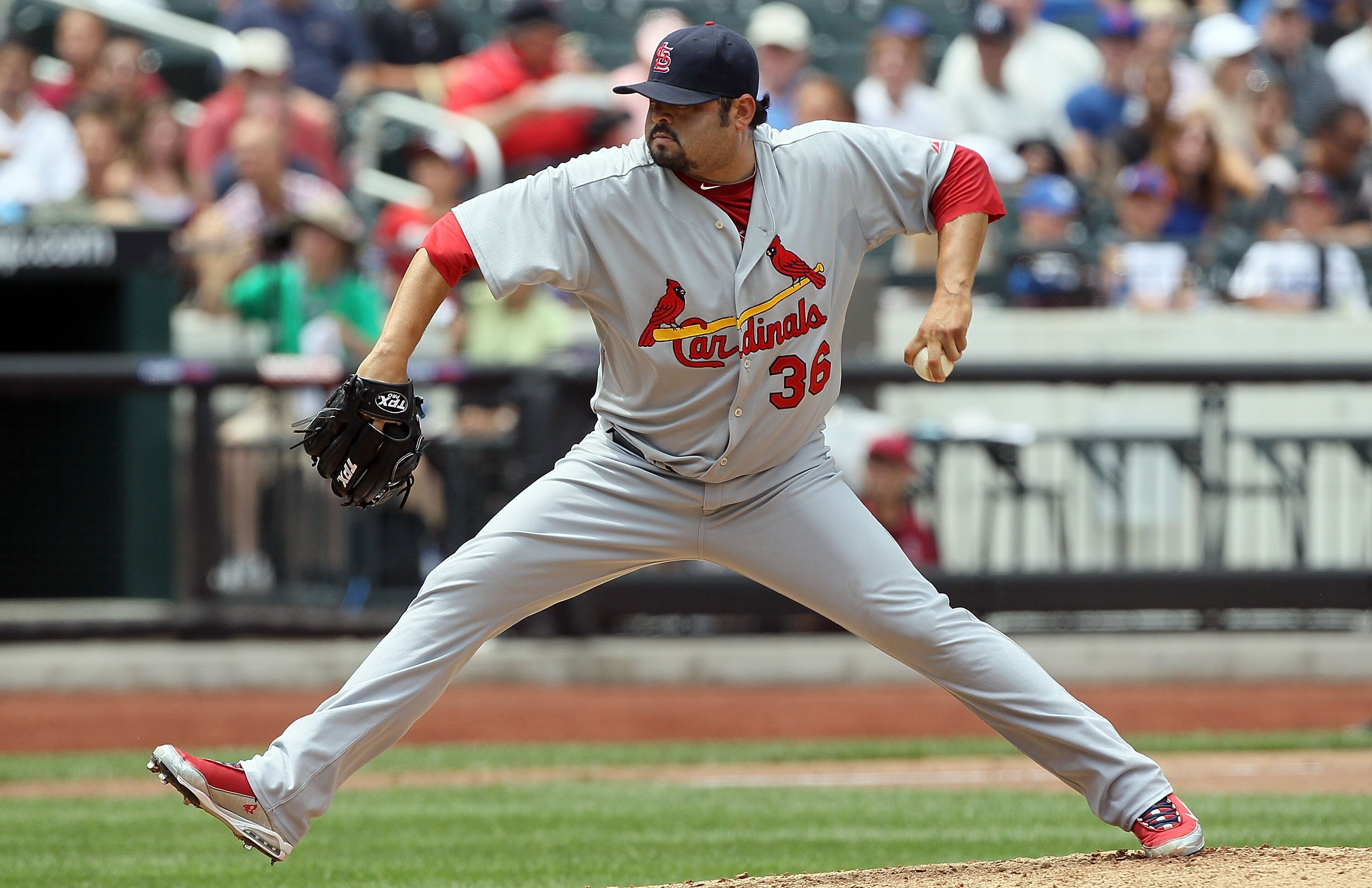 NEW YORK - JULY 29:  Dennys Reyes #36 of the St. Louis Cardinals delivers a pitch against the New York Mets on July 29, 2010 at Citi Field in the Flushing neighborhood of the Queens borough of New York City.  (Photo by Jim McIsaac/Getty Images)