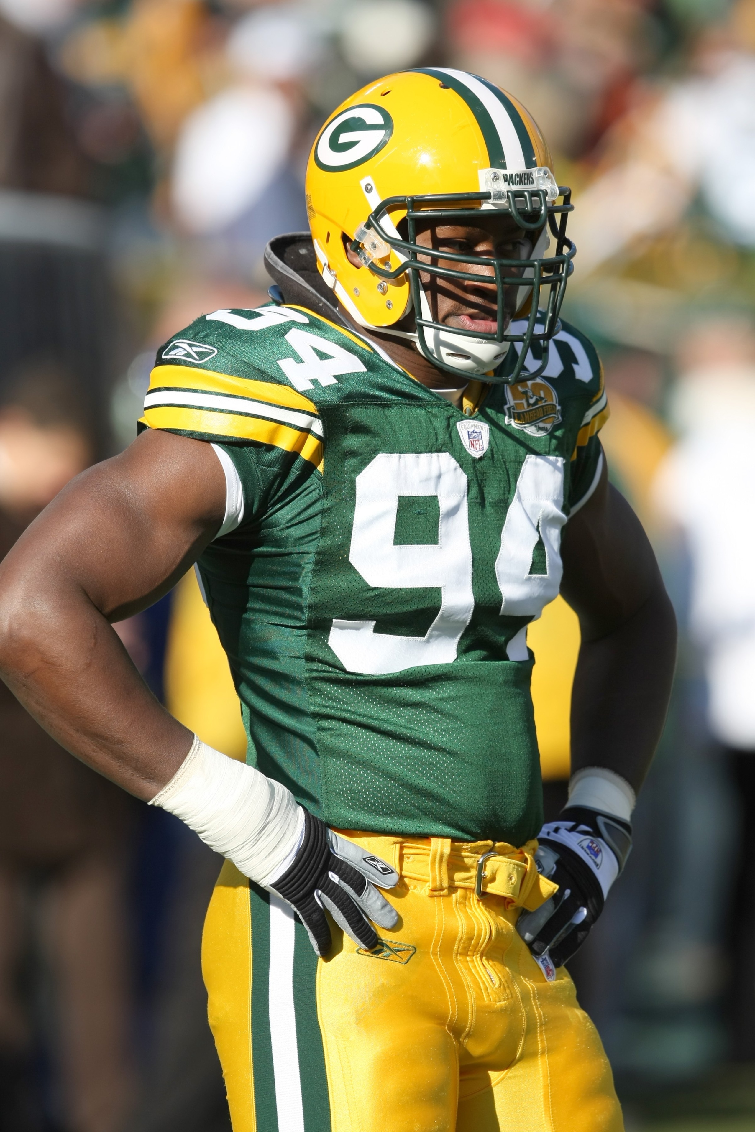 GREEN BAY - NOVEMBER 18:  Kabeer Gbaja-Biamila #94 of the Green Bay Packers looks on during the NFL game against the Carolina Panthers at Lambeau Field on November 18, 2007 in Green Bay, Wisconsin. (Photo by Jonathan Daniel/Getty Images)