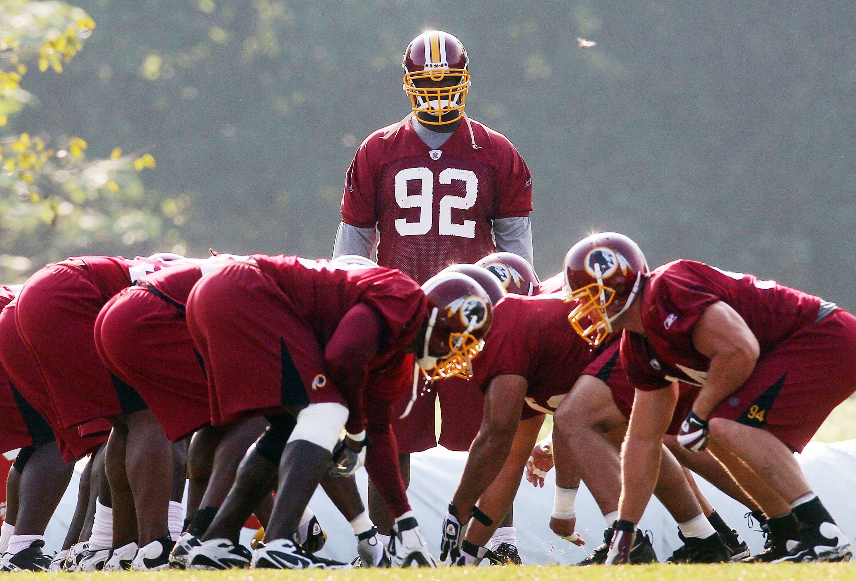 ASHBURN, VA - AUGUST 06:  Defensive lineman Albert Haynesworth #92 of the Washington Redskins watches his teamates practice as he sits out his eighth consecutive day of practice during Redskins training camp on August 6, 2010 in Ashburn, Virginia.  (Photo
