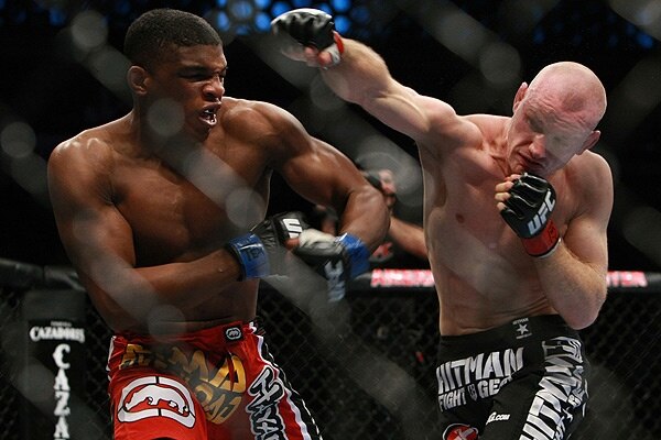 Martin Kampmann delivering an overhand right to Paul Daley