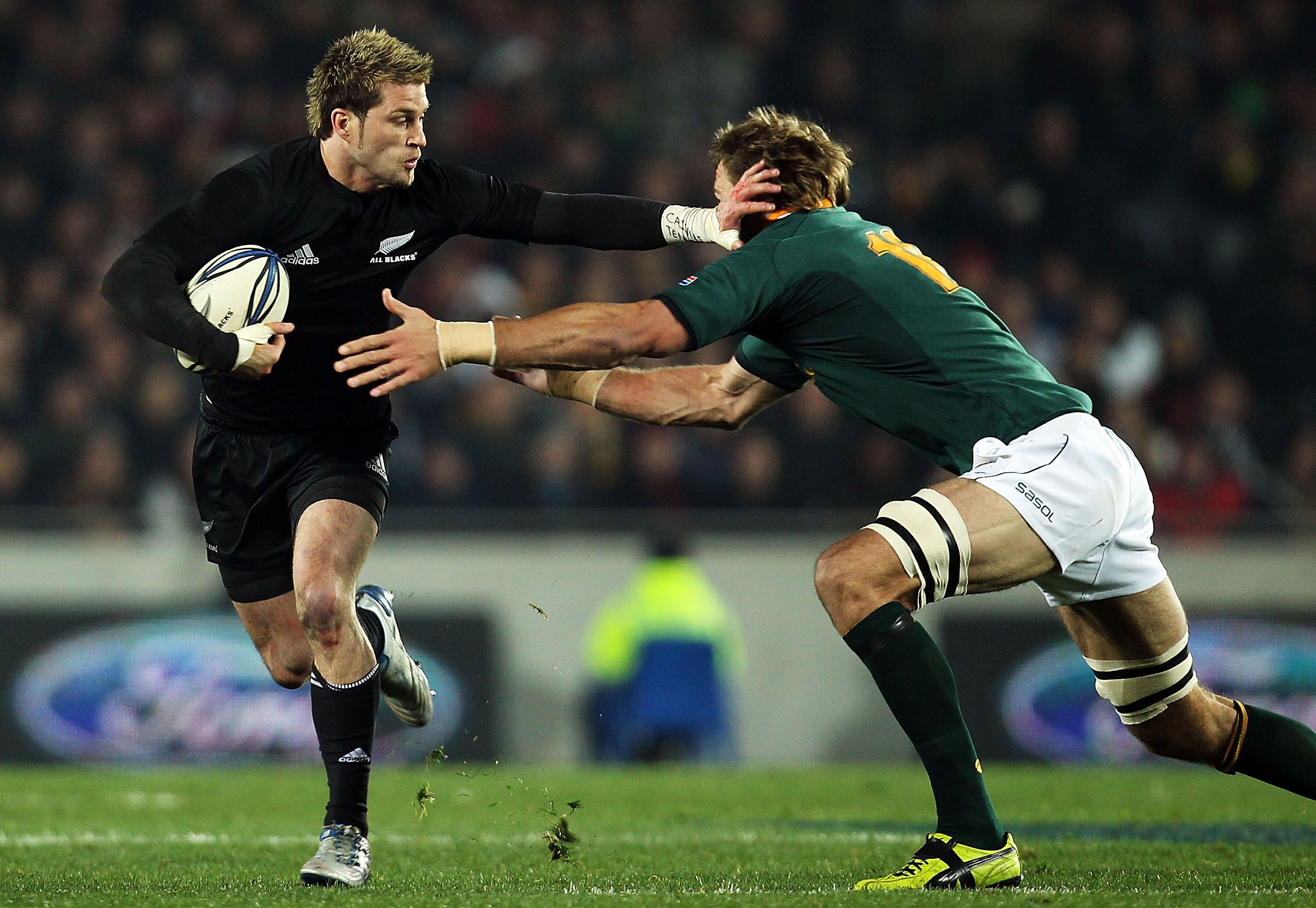 AUCKLAND, NEW ZEALAND - JULY 10:  Cory Jane of the All Blacks makes a break during the Tri-Nations match between the New Zealand All Blacks and South Africa Springboks at Eden Park on July 10, 2010 in Auckland, New Zealand.  (Photo by Hannah Johnston/Gett