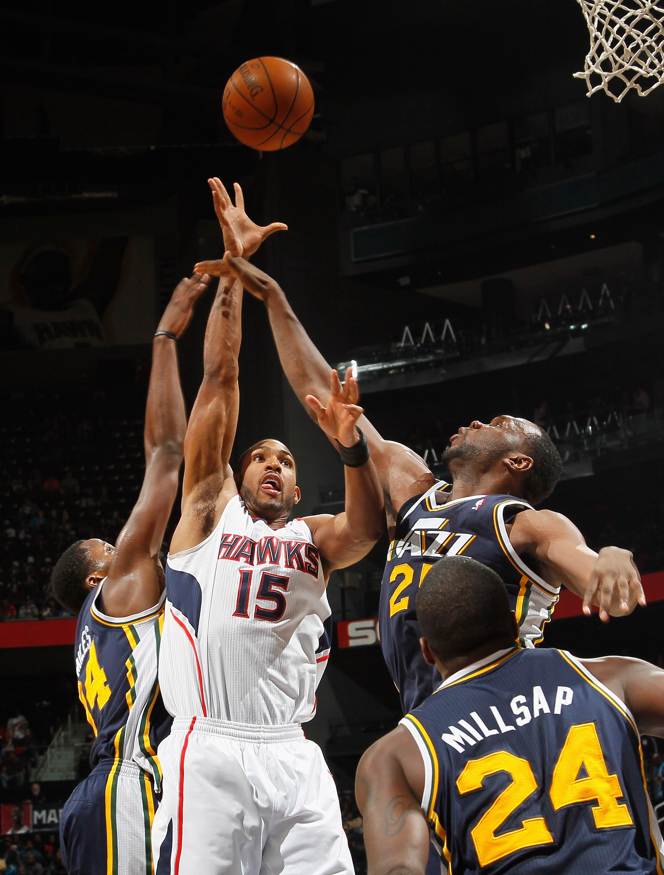 ATLANTA - NOVEMBER 12:  Al Horford #15 of the Atlanta Hawks shoots against C.J. Miles #34, Al Jefferson #25 and Paul Millsap #24 of the Utah Jazz at Philips Arena on November 12, 2010 in Atlanta, Georgia.  NOTE TO USER: User expressly acknowledges and agr