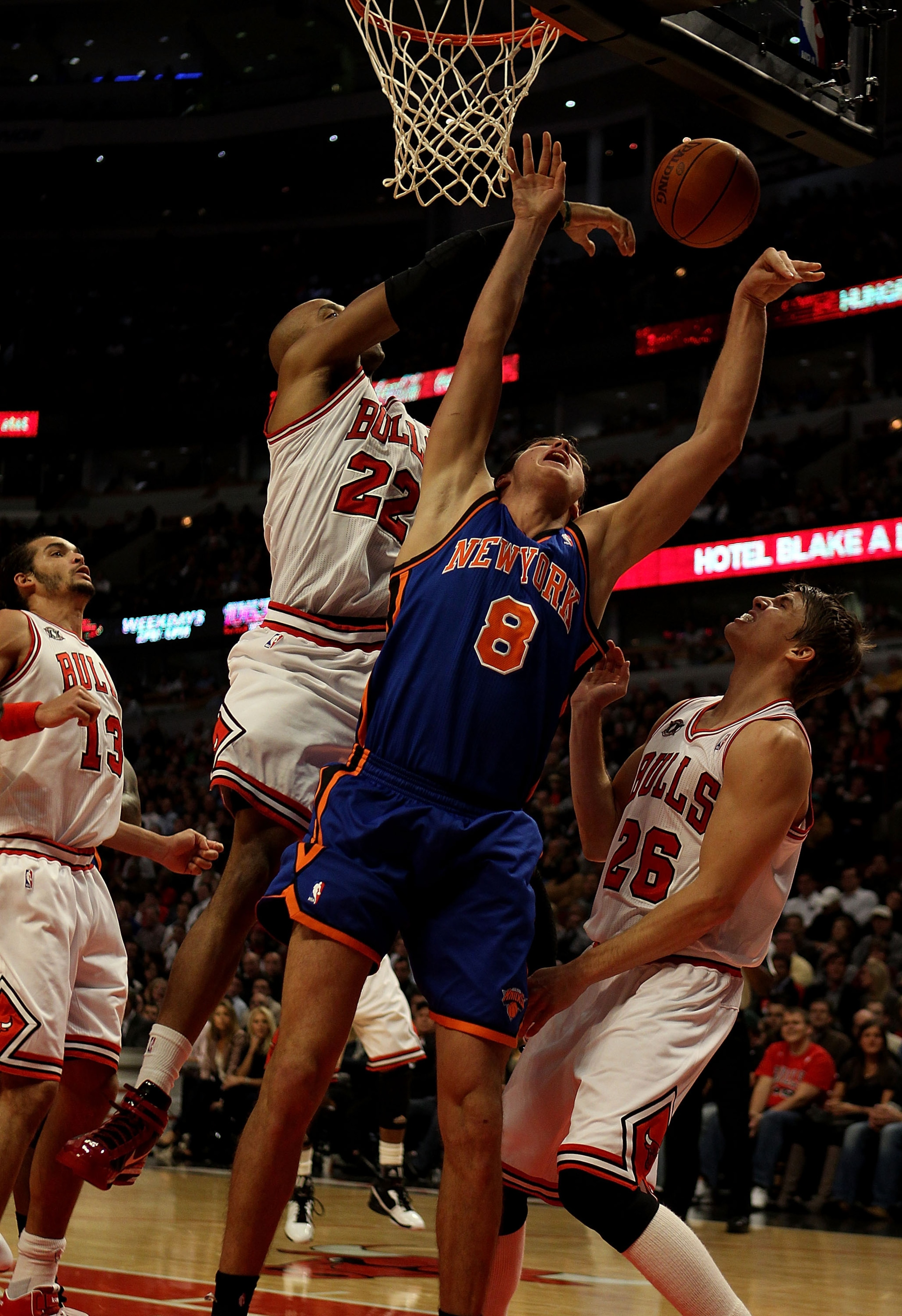 CHICAGO - NOVEMBER 04: Danilo Gallinari #8 of the New York Knicks is fouled while shooting by Taj Gibson #22 of the Chicago Bulls as Kyle Korver #26 defends at the United Center on November 4, 2010 in Chicago, Illinois. NOTE TO USER: User expressly acknow