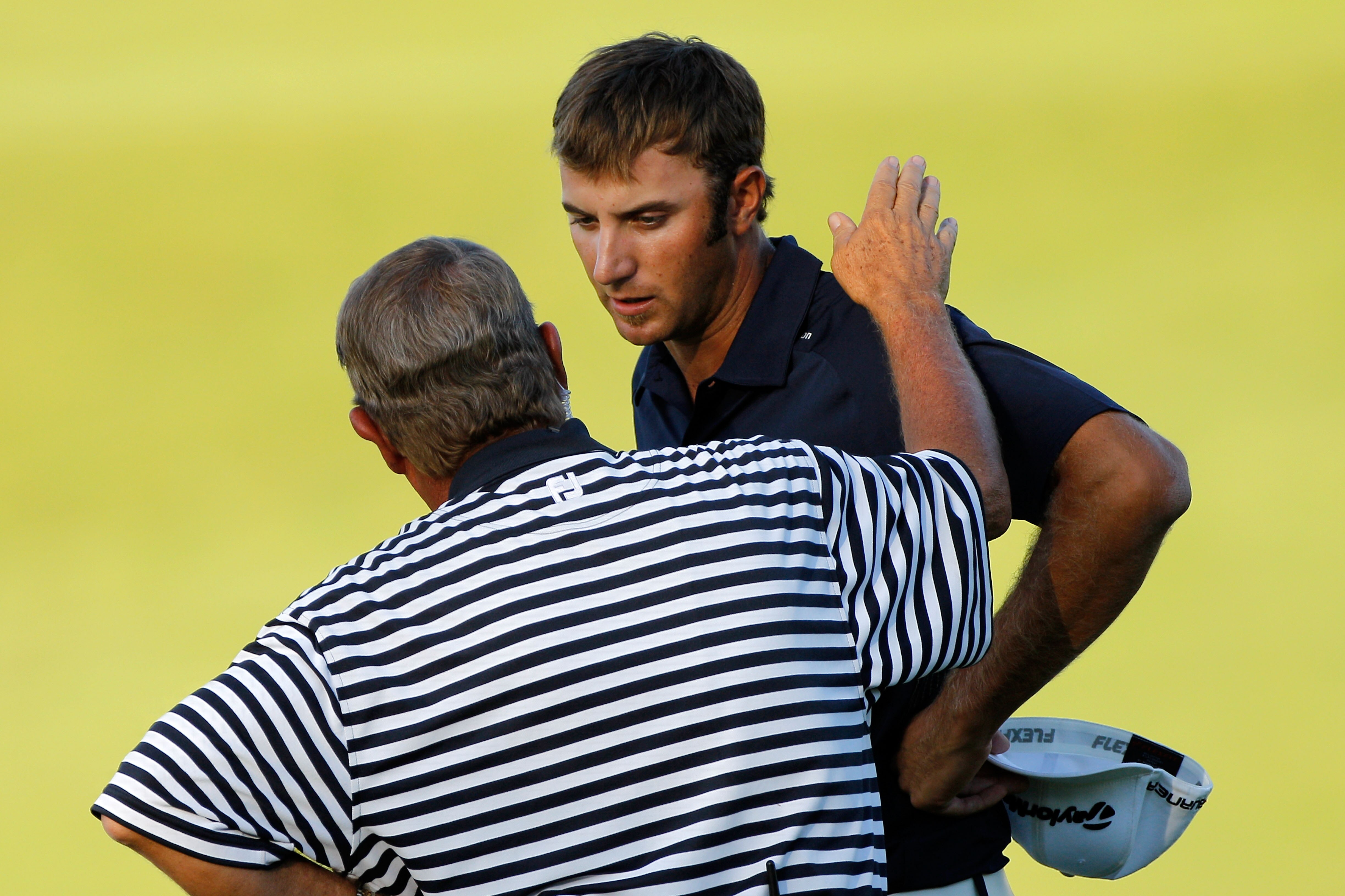 KOHLER, WI - AUGUST 15:  A PGA of America rules official chats with Dustin Johnson (R) on the 18th green during the final round of the 92nd PGA Championship on the Straits Course at Whistling Straits on August 15, 2010 in Kohler, Wisconsin.  (Photo by Sam