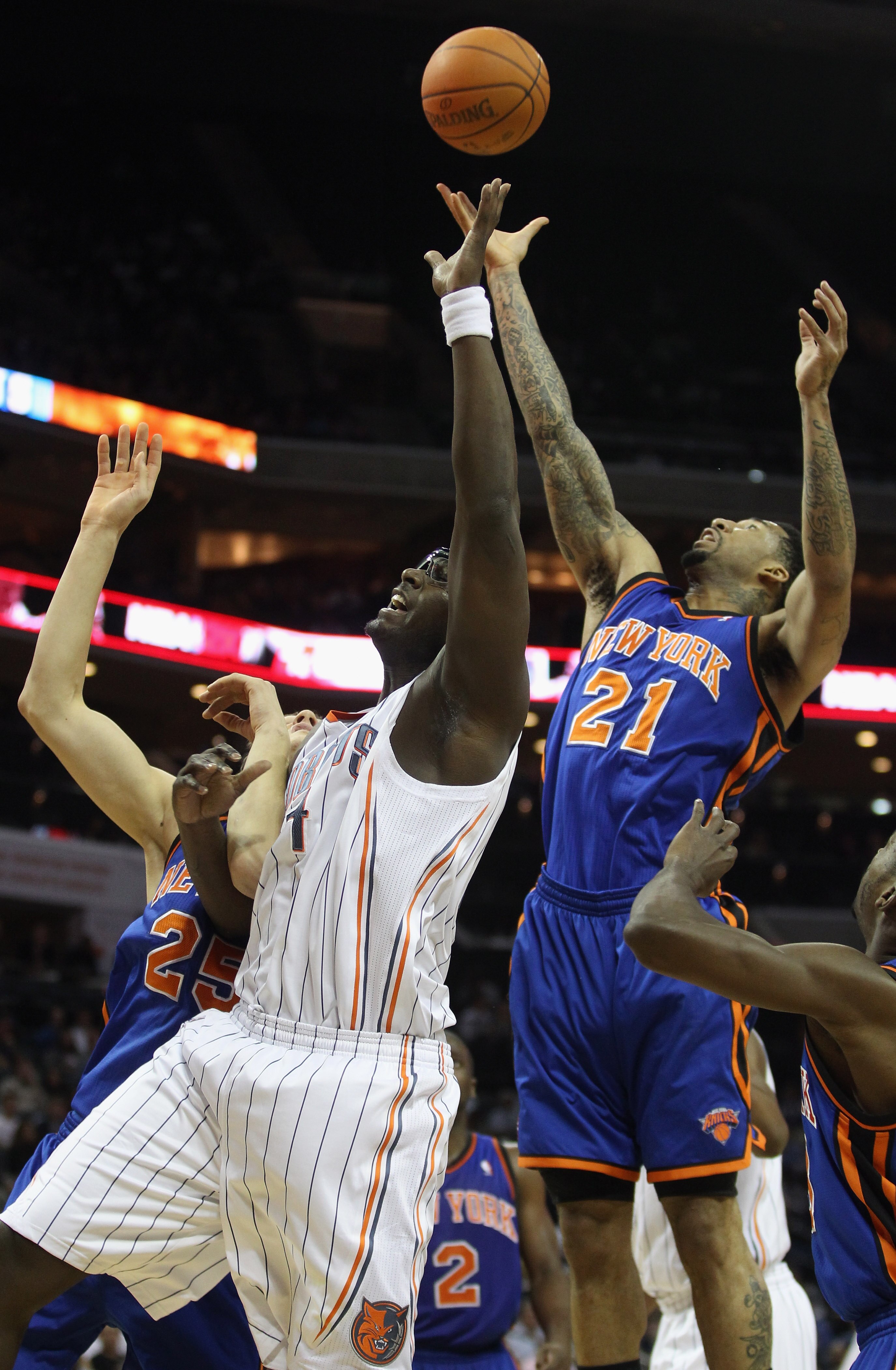 CHARLOTTE, NC - NOVEMBER 24:  Wilson Chandler #21 of the New York Knicks goes up for a loose ball with Kwame Brown #54 of the Charlotte Bobcats during their game at Time Warner Cable Arena on November 24, 2010 in Charlotte, North Carolina.  NOTE TO USER:
