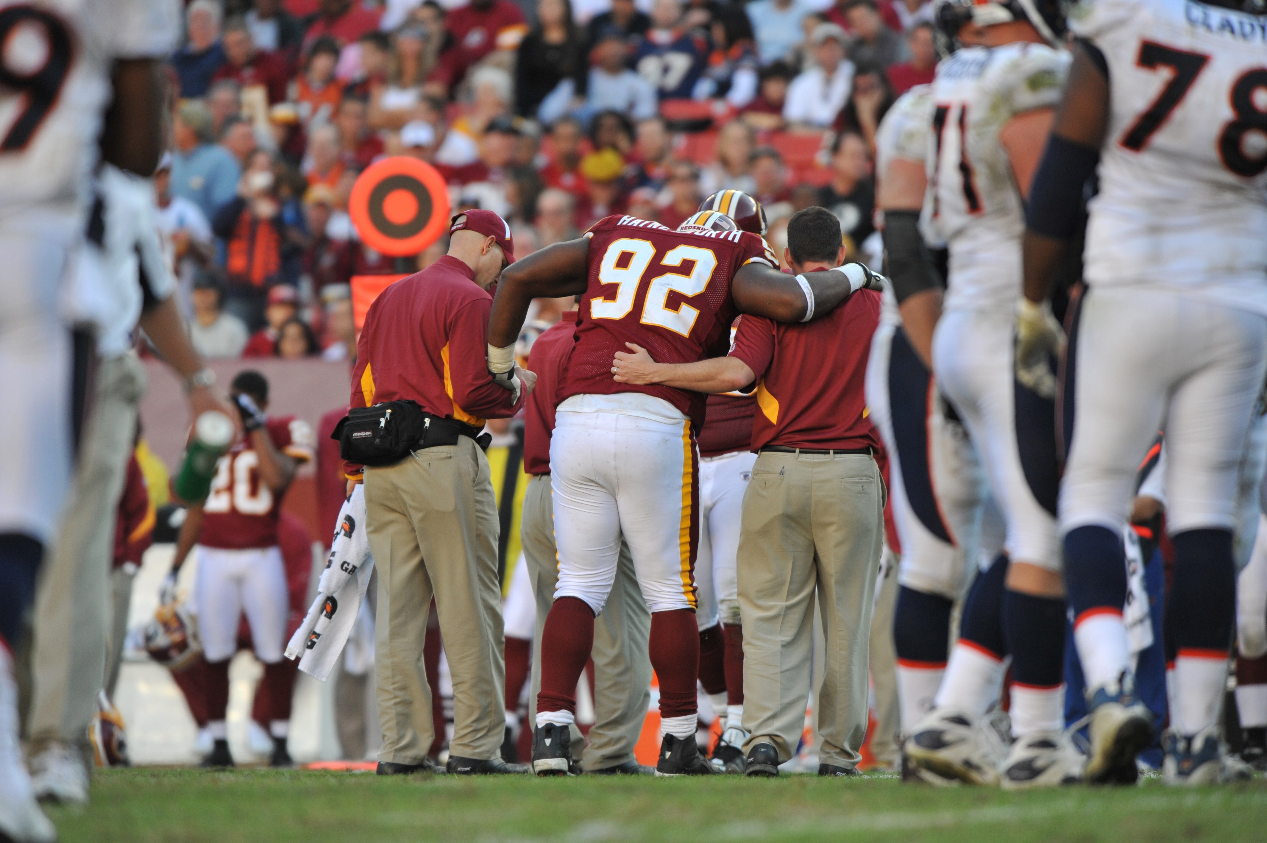LANDOVER, MD - NOVEMBER 15:  Albert Haynesworth #92 of the Washington Redskins is helped off the field during the game against the Denver Broncos at FedExField on November 15, 2009 in Landover, Maryland. The Redskins defeated the Broncos 27-17. (Photo by