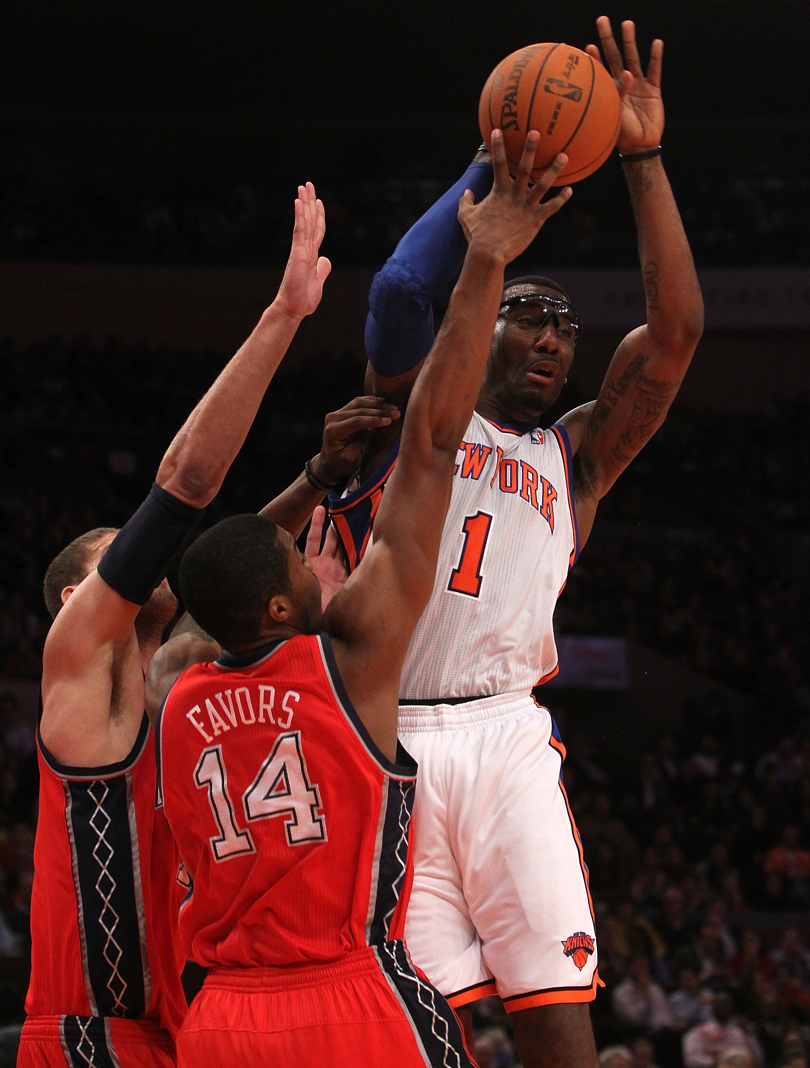 NEW YORK, NY - NOVEMBER 30:  Amar'e Stoudemire #1 of the New York Knicks is double teamed by Brook Lopez #11 and Derrick Favors #14 of the New Jersey Nets on November 30, 2010 at Madison Square Garden in New York City. NOTE TO USER: User expressly acknowl