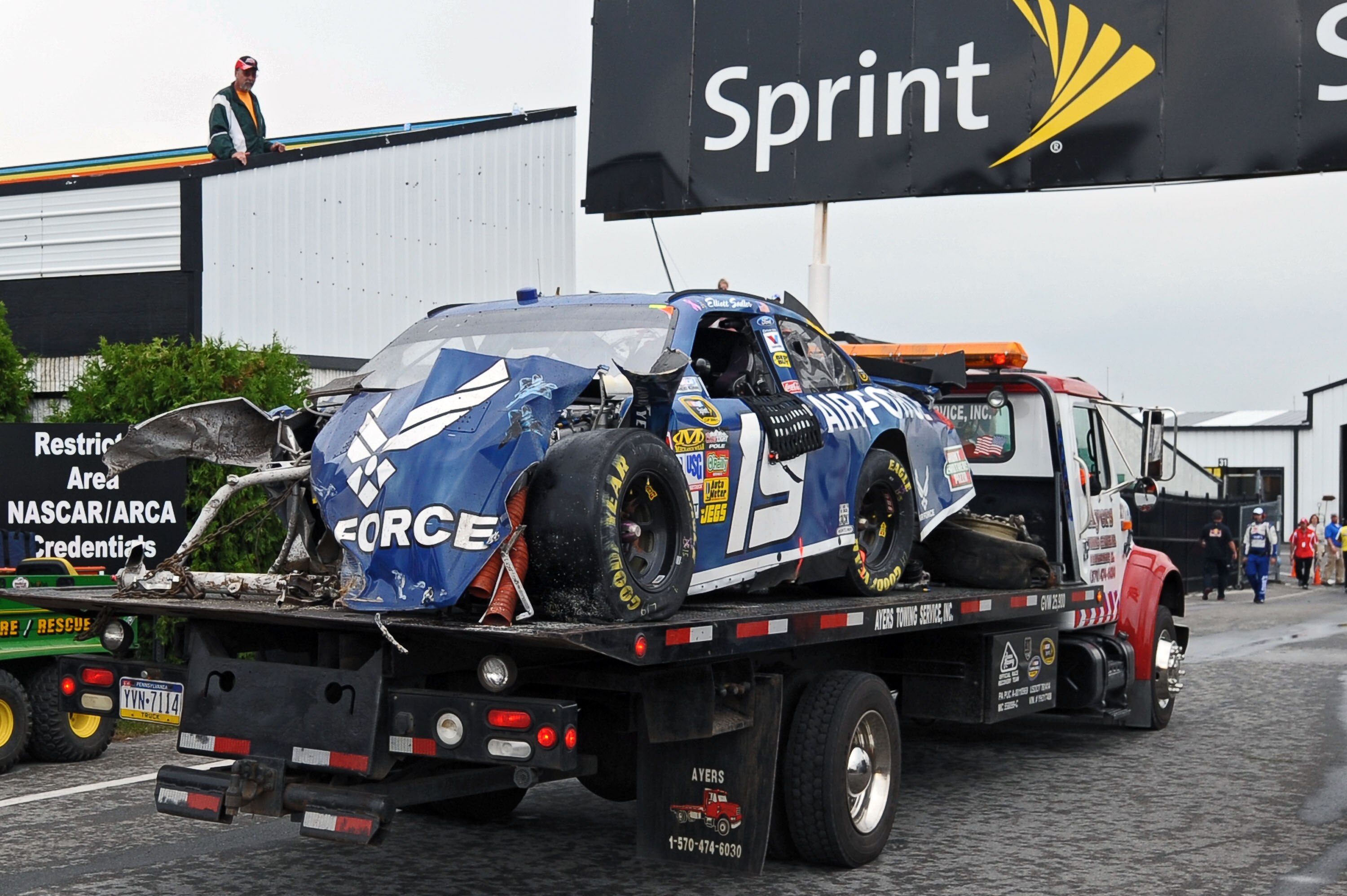LONG POND, PA - AUGUST 01:  The wrecked #19 Air Force Ford, driven by Elliott Sadler, gets towed through the garage area after he hit the wall in the NASCAR Sprint Cup Series Sunoco Red Cross Pennsylvania 500 at Pocono Raceway on August 1, 2010 in Long Po