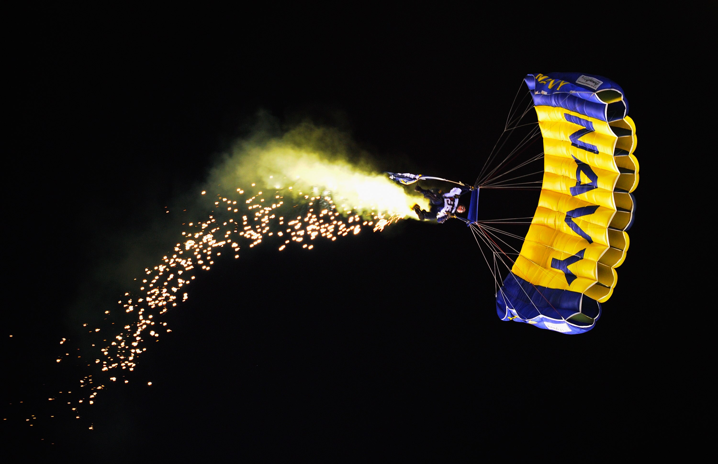 SAN DIEGO - NOVEMBER 22: A mamber of US Navy Seal Leapfrog parachute team performs prior to the start of the football game between the Denver Broncos and the San Diego Chargers at Qualcomm Stadium on November 22, 2010 in San Diego, California.  (Photo by
