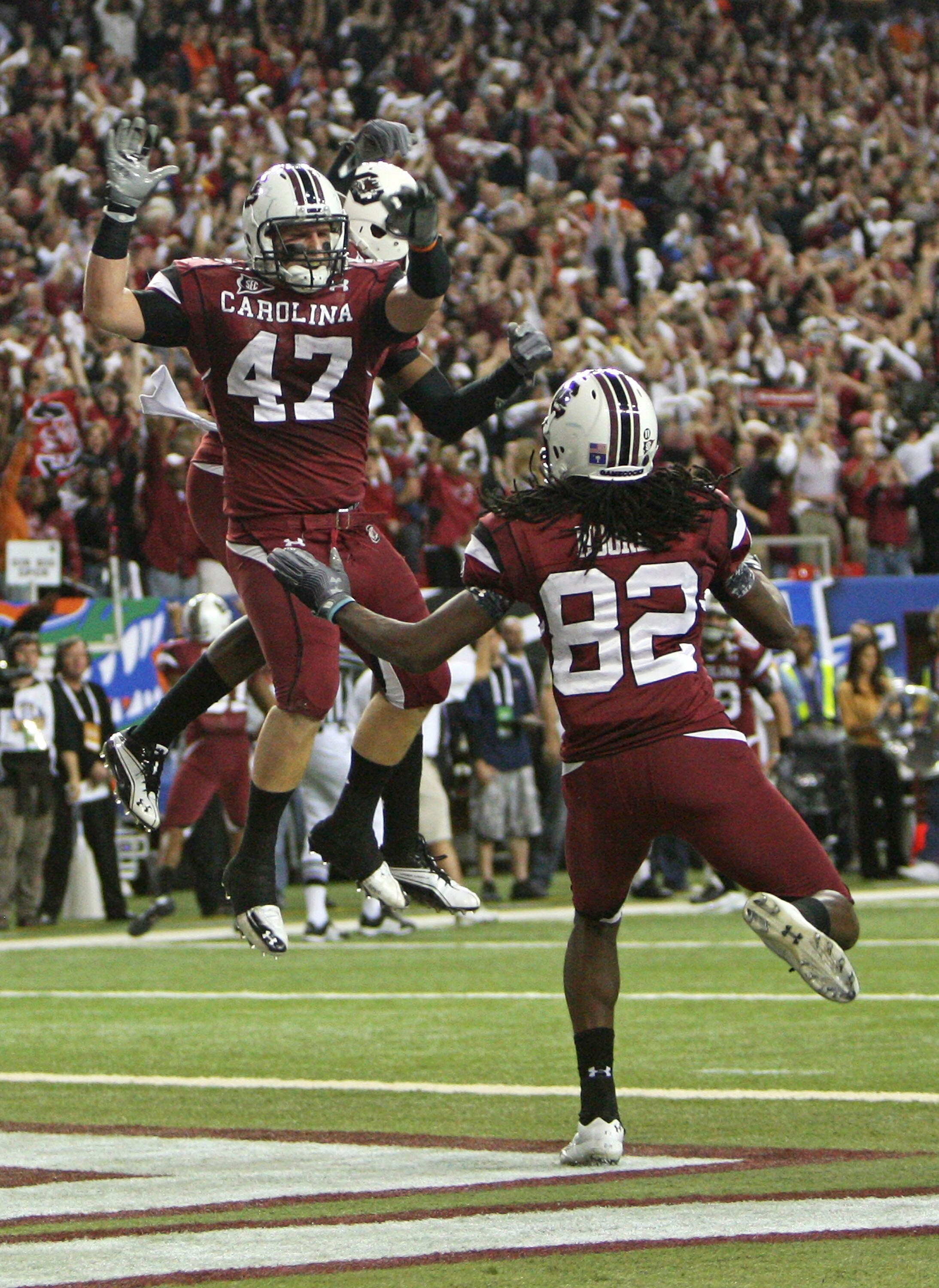 ATLANTA - DECEMBER 4:  Fullback Patrick DiMarco #47 of the South Carolina Gamecocks celebrates a touchdown while teammate and wide receiver D.L. Moore #82 joins him during the 2010 SEC Championship against the Auburn Tigers at Georgia Dome on December 4,
