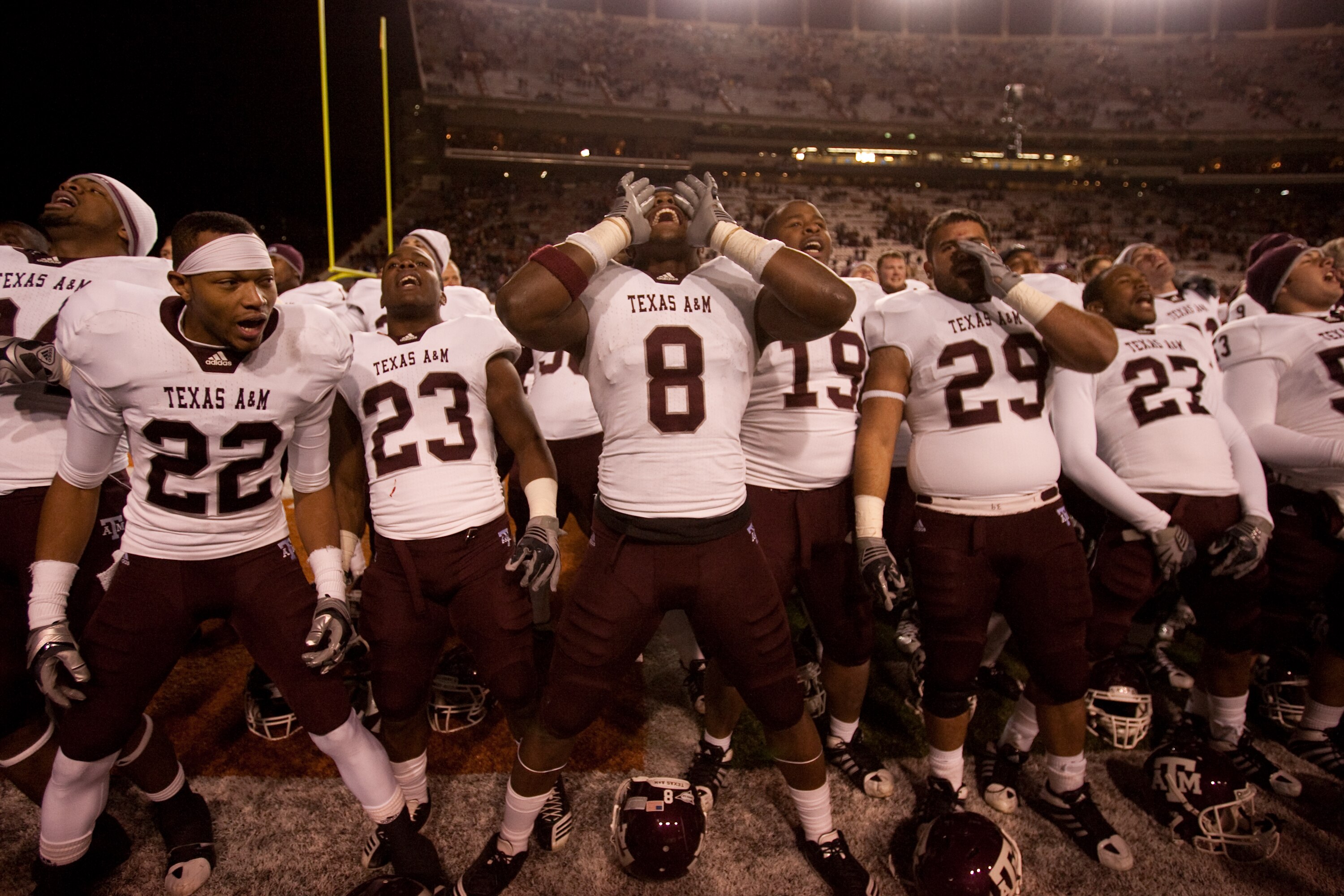 AUSTIN, TX - NOVEMBER 25:  Texas A&M players (L-R) Dustin Harris #22, Ben Malena #23, Jeff Fuller #8, Michael Lamothe #19, Blane Cheatham #29, and C.J. Jones #27 celebrate Texas A&M's 24-17 win over the University of Texas at Darrell K. Royal-Texas Memori