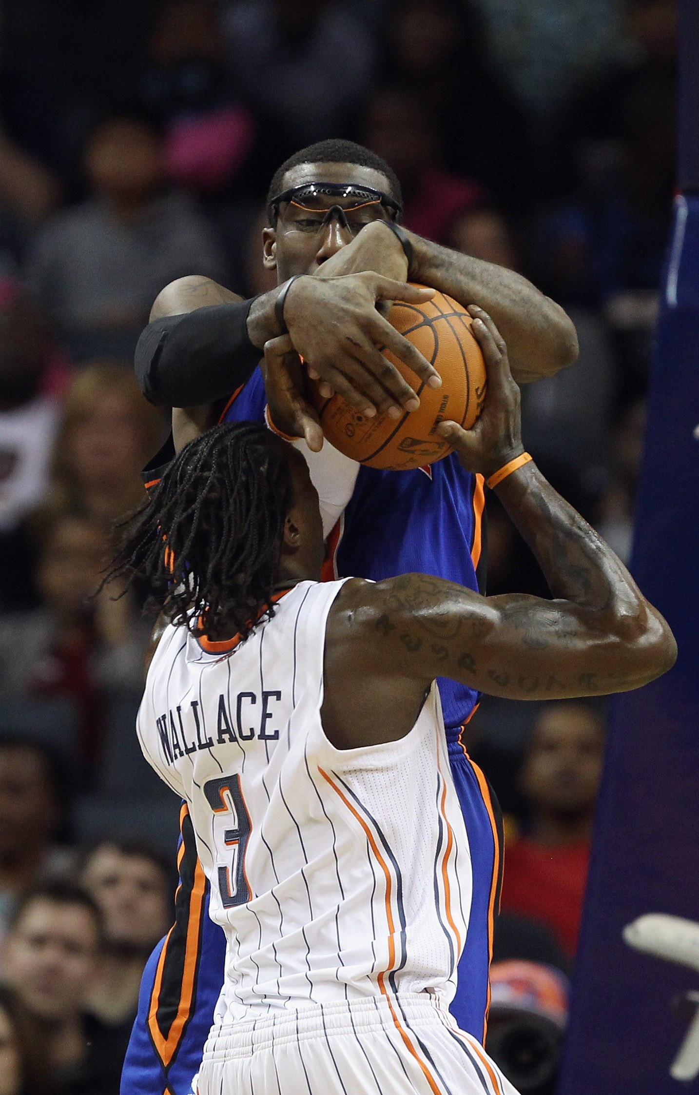 CHARLOTTE, NC - NOVEMBER 24:  Amare Stoudemire #1 of the New York Knicks stops Gerald Wallace #3 of the Charlotte Bobcats during their game at Time Warner Cable Arena on November 24, 2010 in Charlotte, North Carolina.  NOTE TO USER: User expressly acknowl