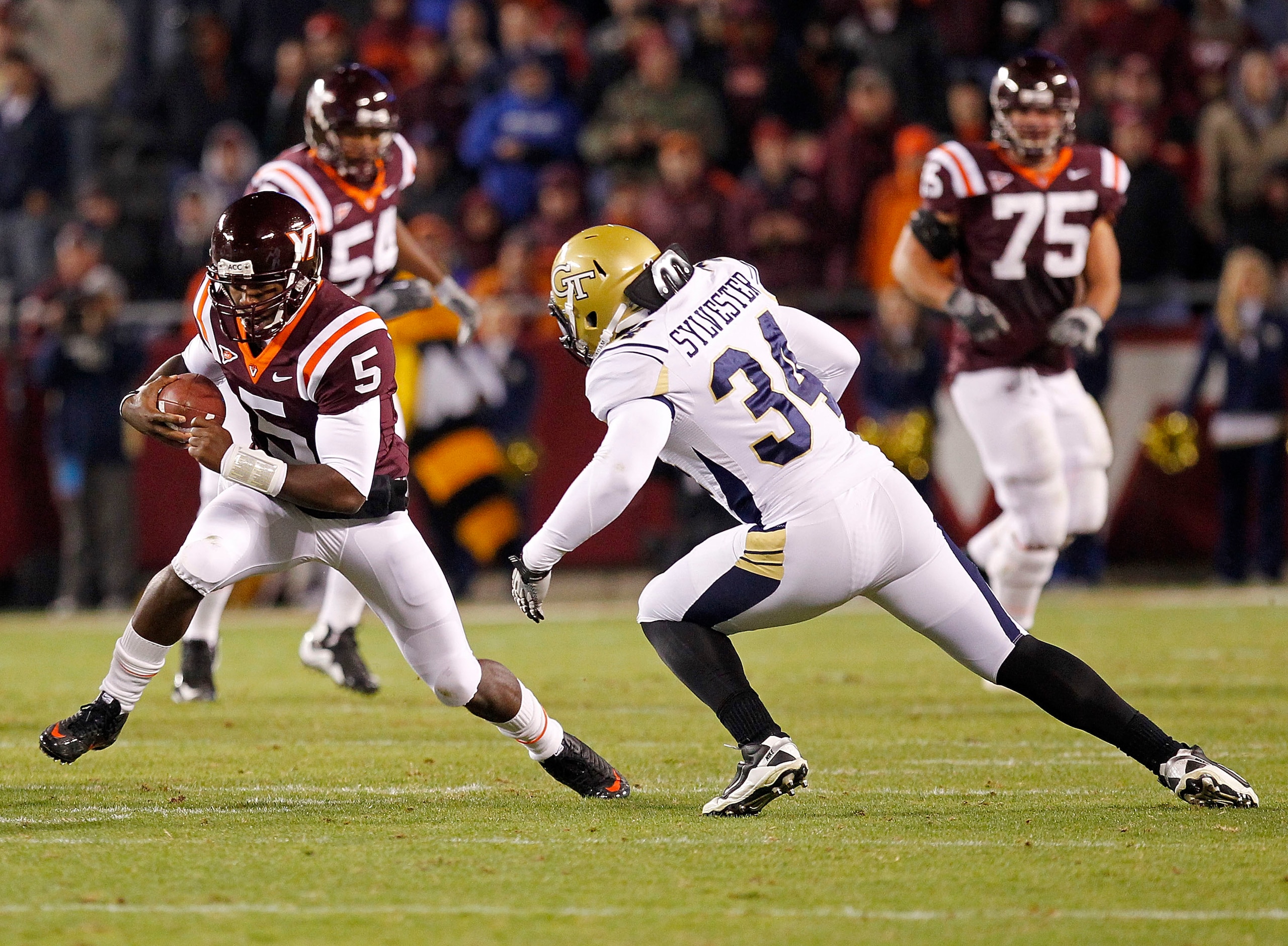 BLACKSBURG, VA - NOVEMBER 04: Quarterback Tyrod Taylor #5 of the Virginia Tech Hokies runs with the ball as linebacker Steven Sylvester #34 of the Georgia Tech Yellow Jackets chases at Lane Stadium on November 4, 2010 in Blacksburg, Virginia.  (Photo by G